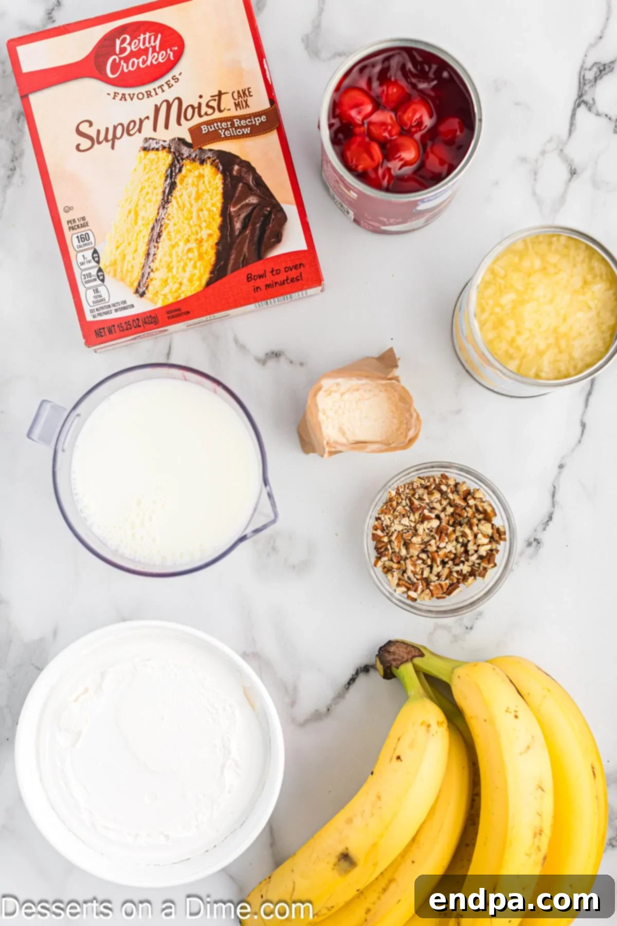 A colorful array of ingredients for Punch Bowl Cake, including bananas, cake mix, crushed pineapple, pudding mix, milk, nuts, and pie filling, neatly arranged for preparation.