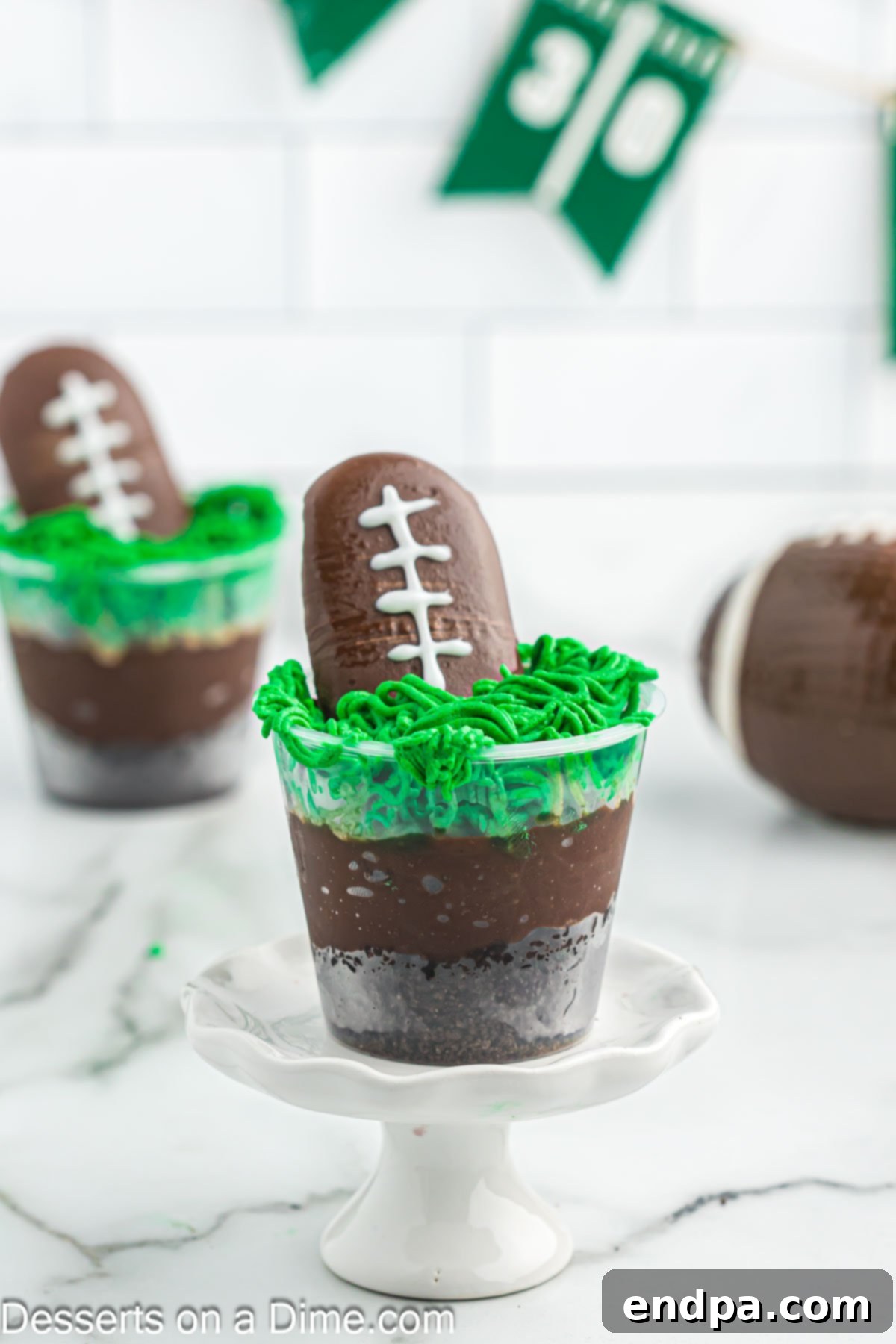 Football dirt cups ready to serve on stand.
