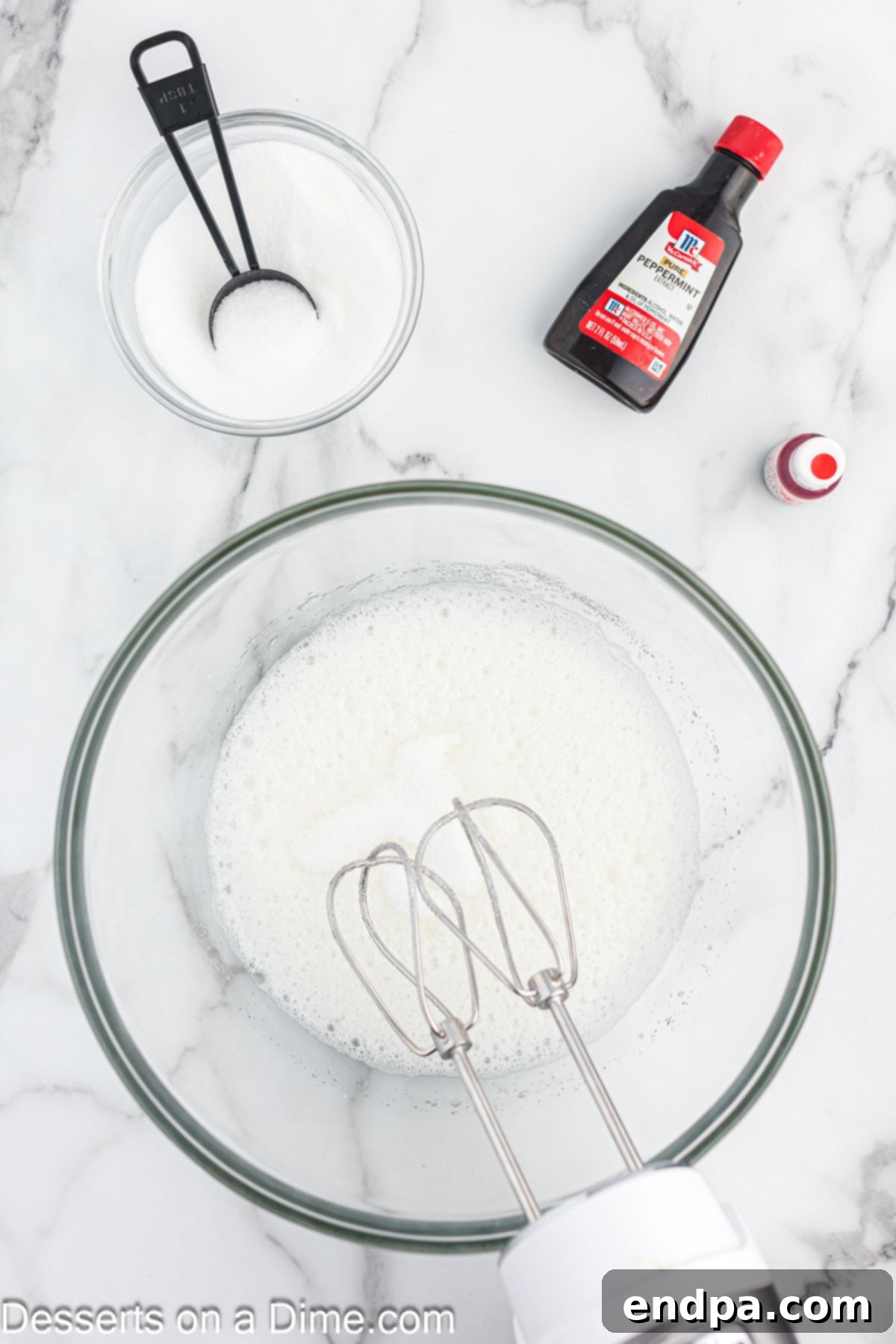 Peppermint Cloud Kisses 5 Mixing bowl with sugar slowly added to egg whites, forming glossy peaks.