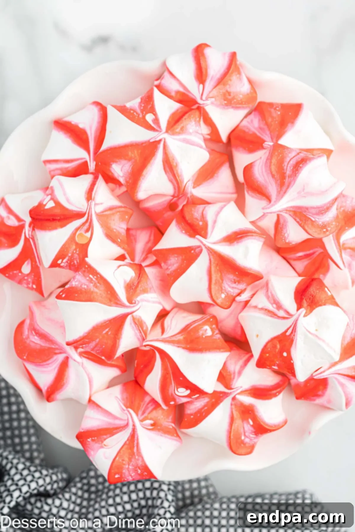 Peppermint Cloud Kisses 8 A close-up view of perfectly baked peppermint meringue cookies, stacked and ready for serving.