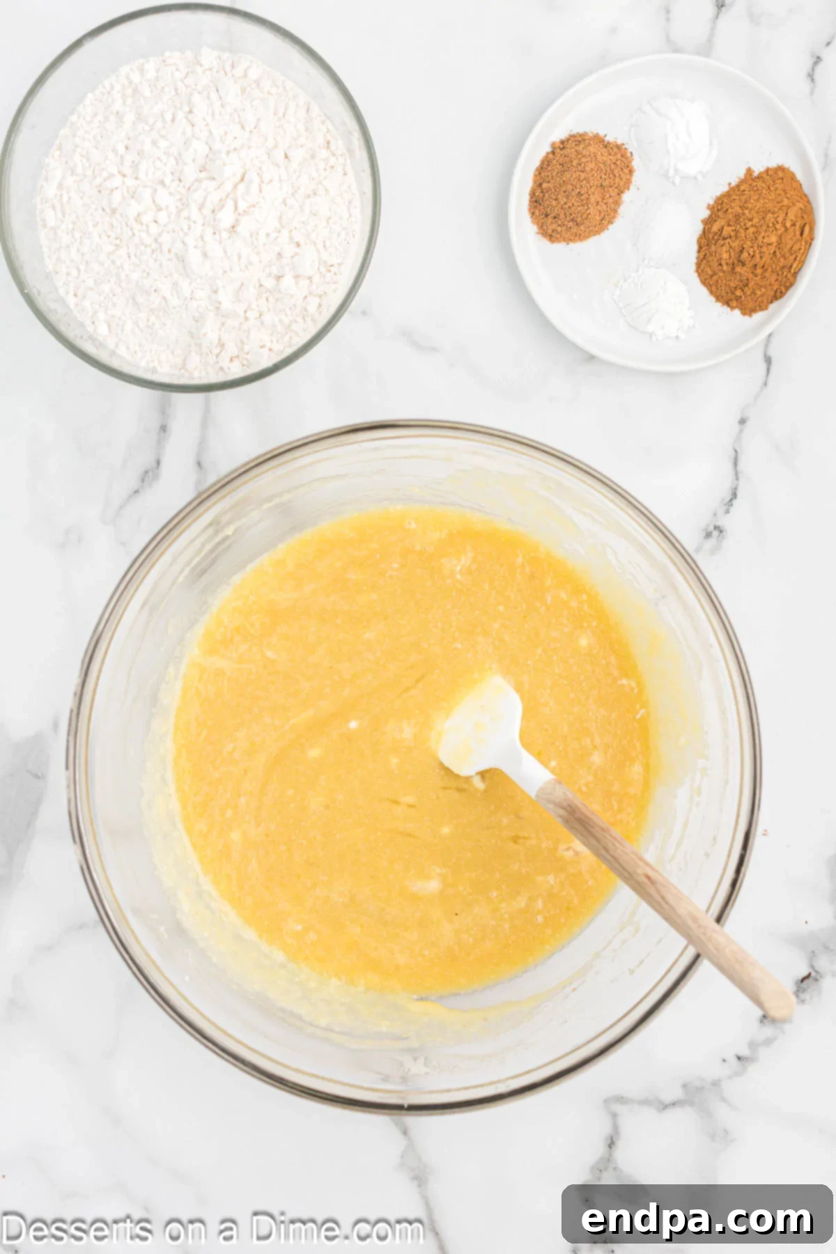 Bowl of wet ingredients combined for applesauce bread.