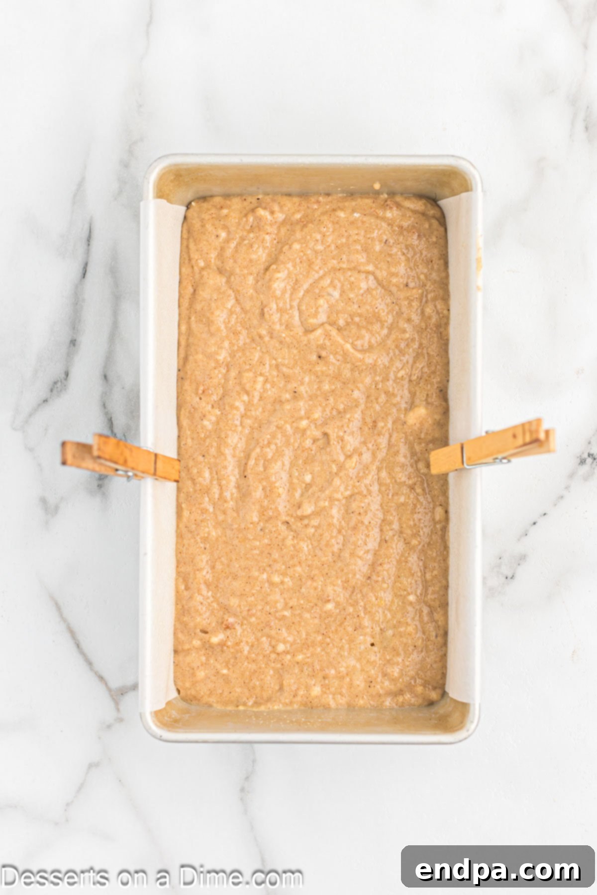 Applesauce bread batter in a loaf pan before baking.
