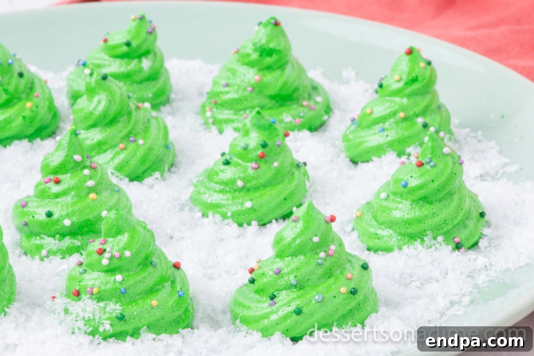 Festive Meringue Christmas Trees 2 Meringue Christmas Trees arranged together on a platter.