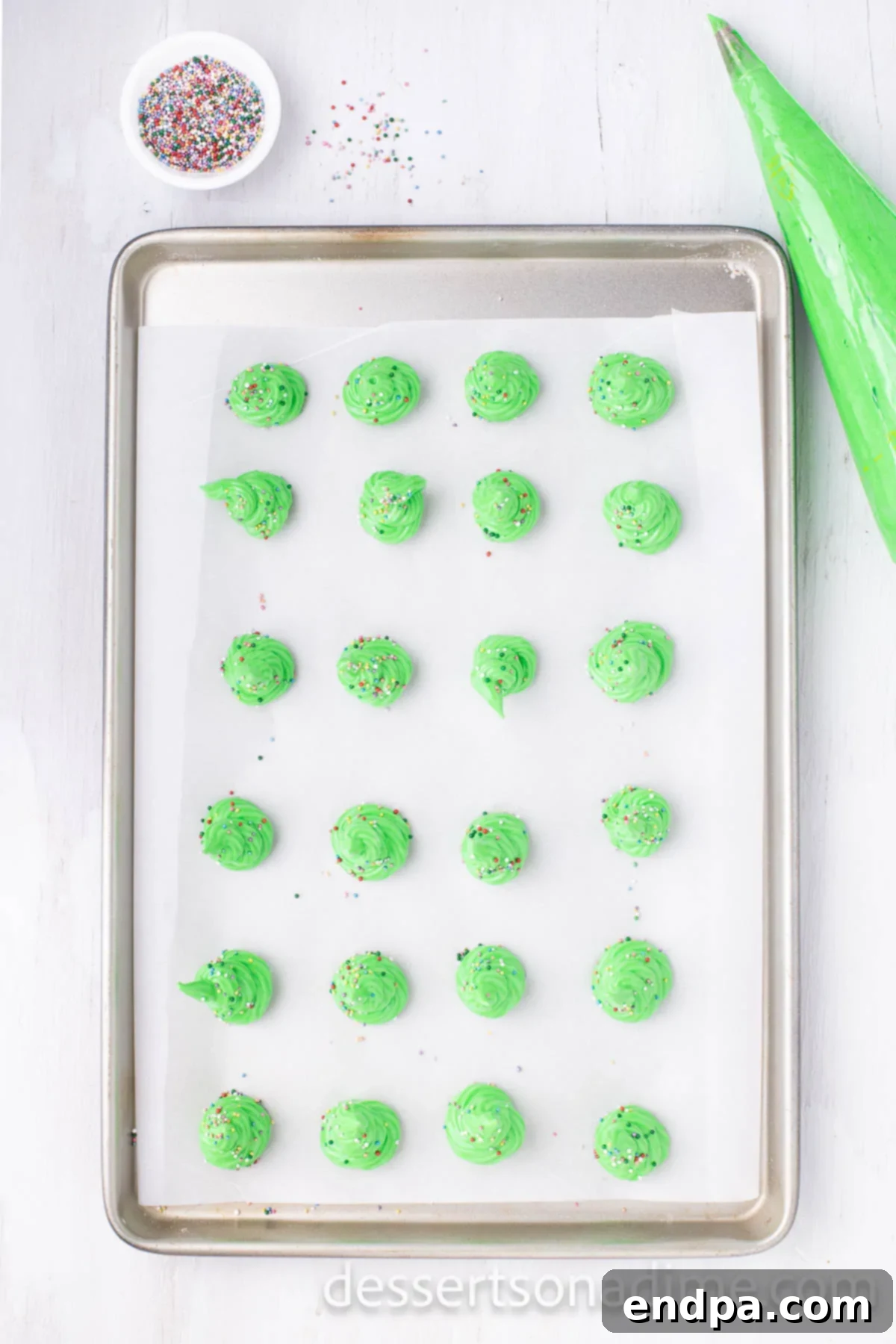 Festive Meringue Christmas Trees 8 Trees piped on a cookie sheet.