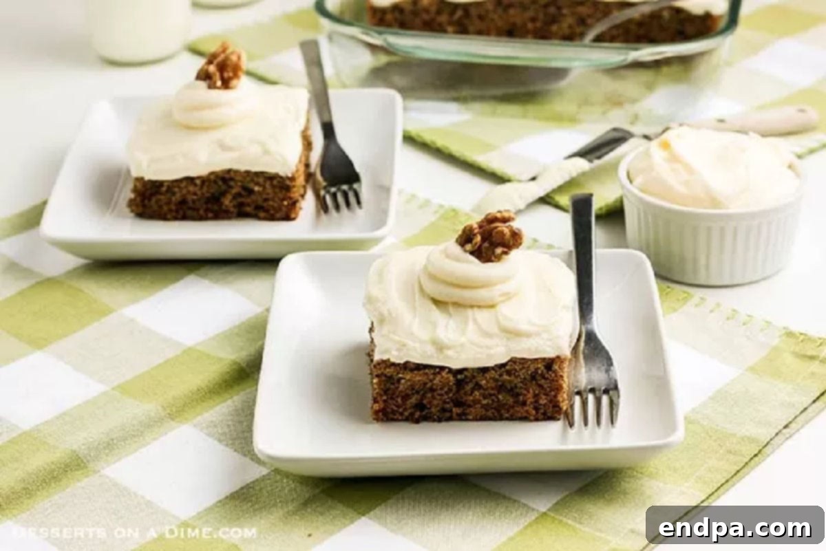 A beautifully frosted Zucchini Cake, already sliced and ready to be served, showcasing its moist texture and creamy topping.