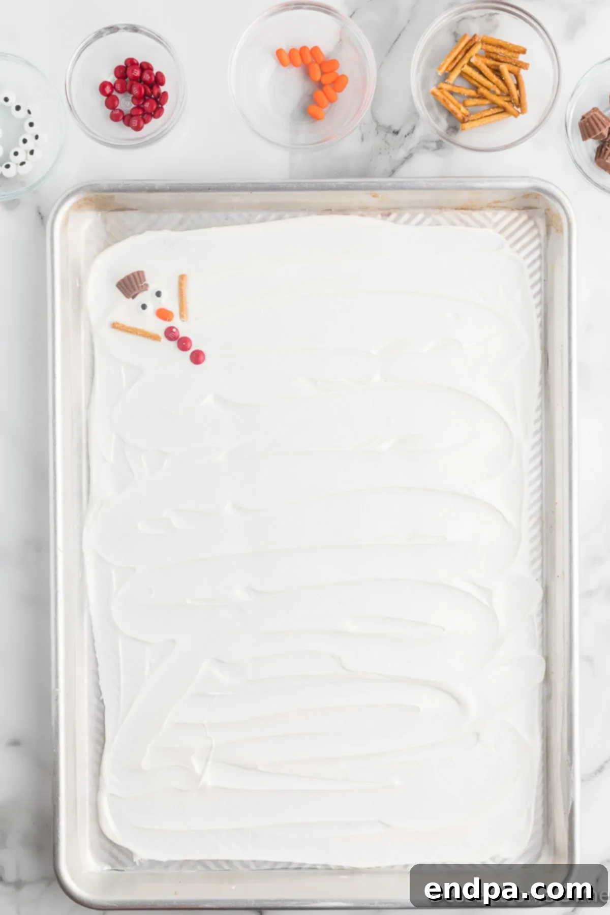 Frosty Meltdown Bark 8 Broken pretzel pieces carefully positioned as the arms of the melted snowmen.