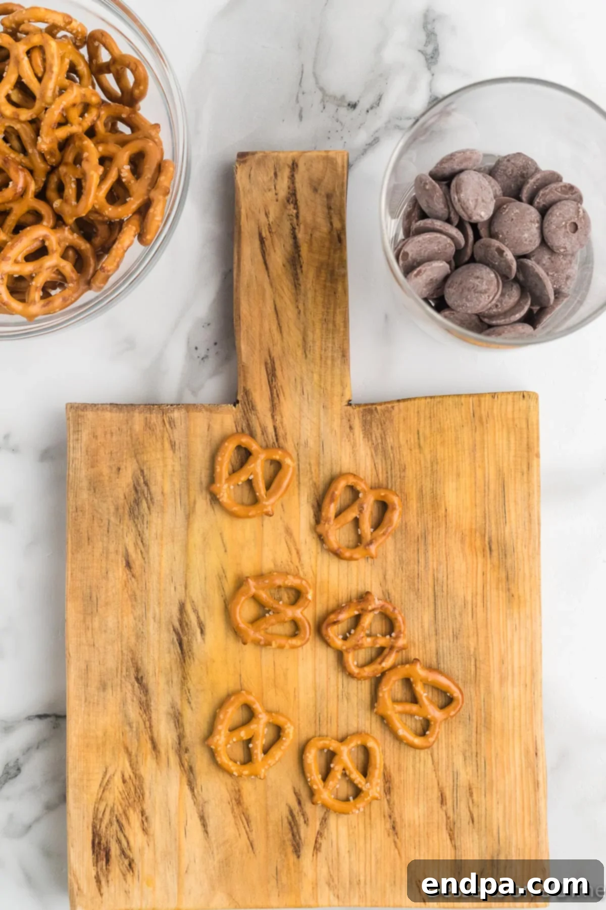 Pretzel twists carefully broken into antler shapes, laid out on a wooden board.
