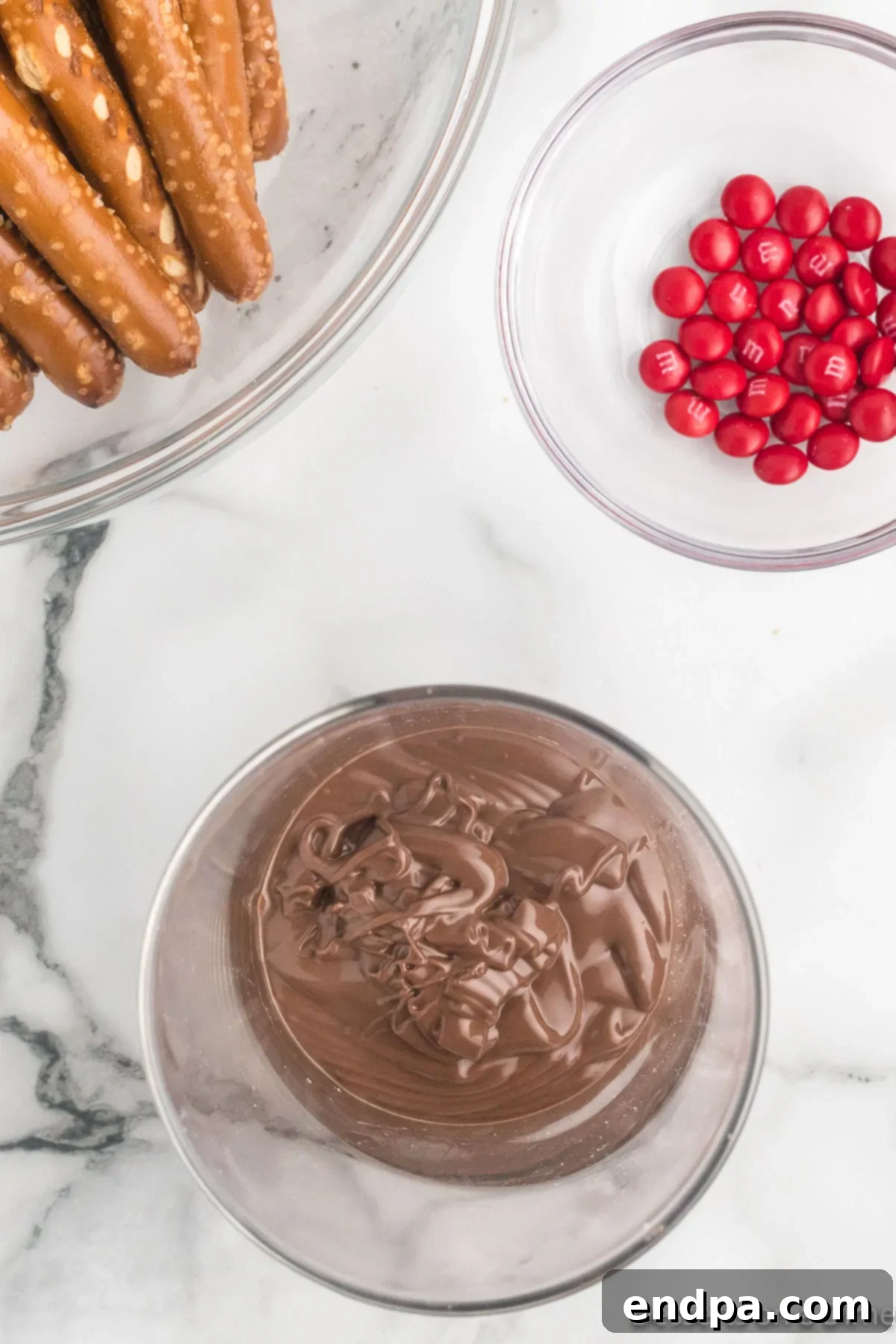 Smooth, melted chocolate in a tall, microwave-safe bowl, ready for dipping.