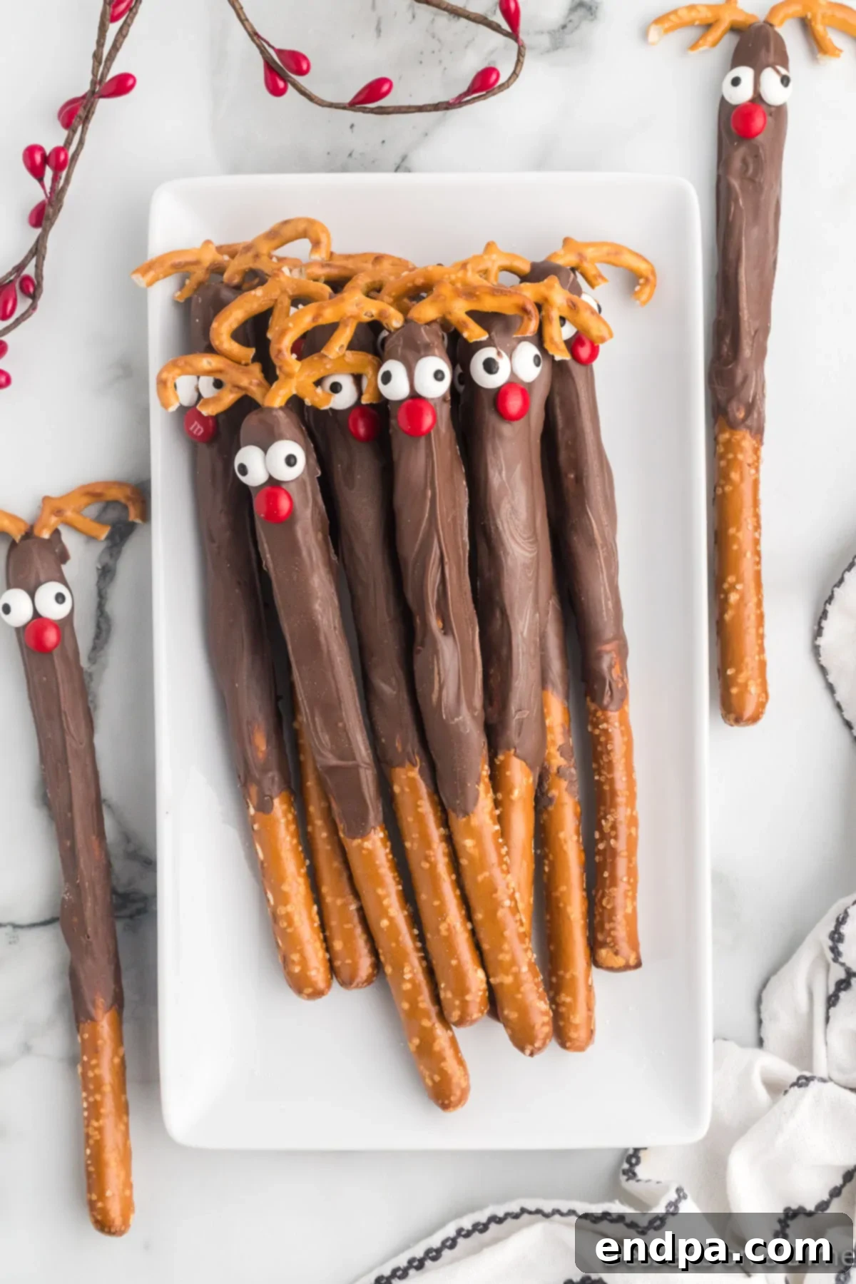 A festive platter filled with beautifully arranged Reindeer Pretzel Rods, ready to be served or gifted for the holidays.
