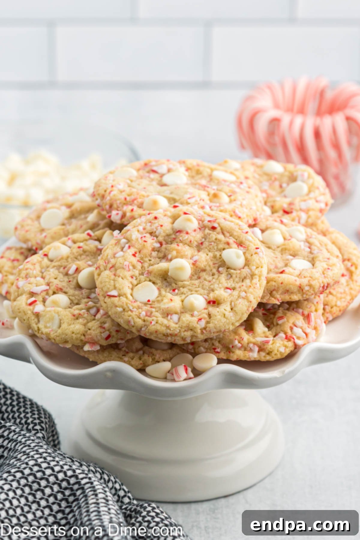 Peppermint White Chocolate Delights 2 White Chocolate Peppermint Cookies stacked on a pedestal.