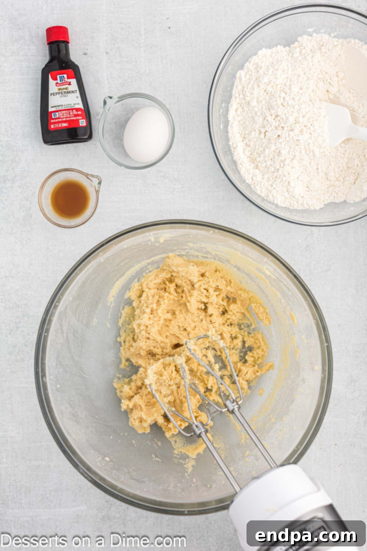 Peppermint White Chocolate Delights 6 Mixing bowl gradually combining wet ingredients with flour mixture.