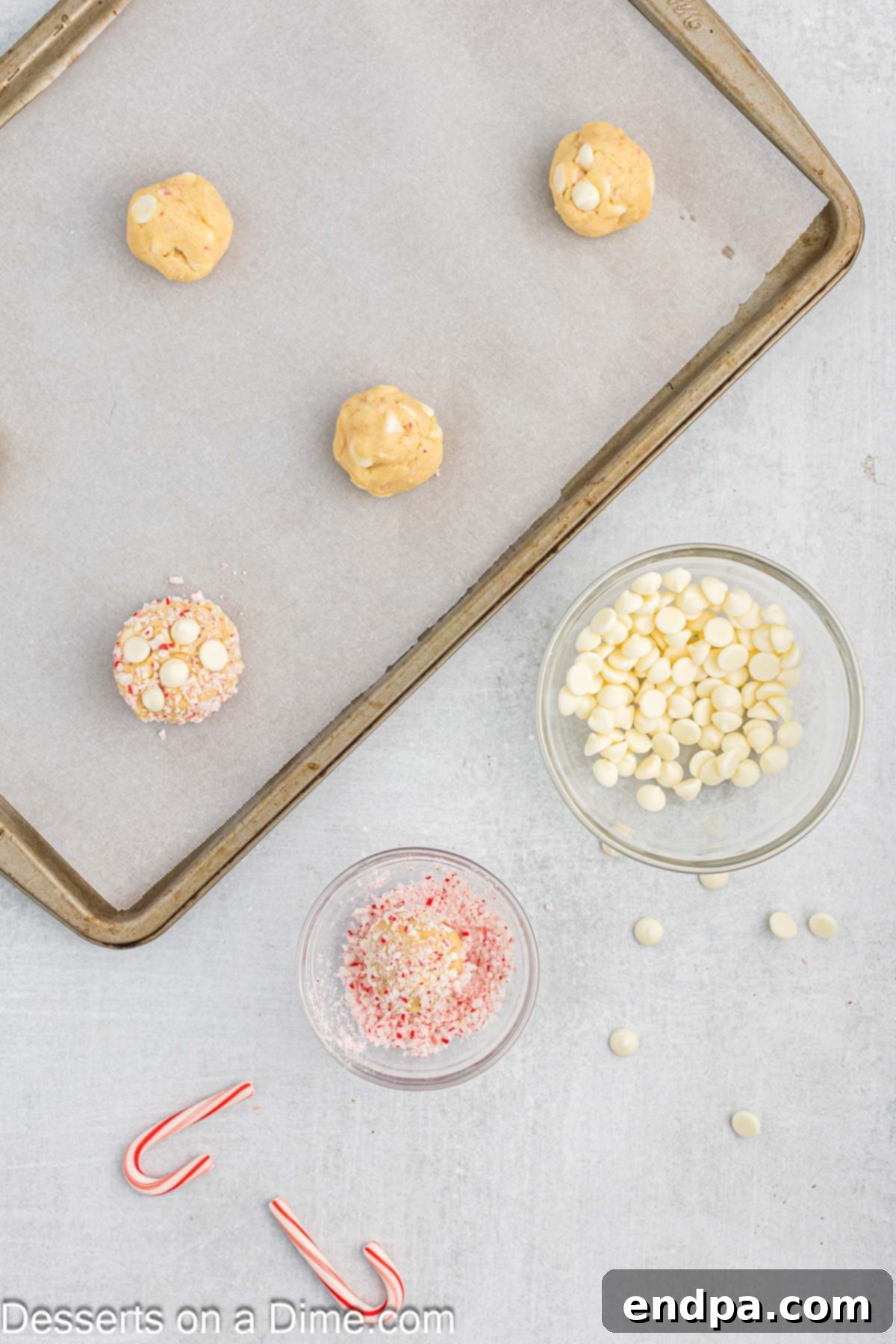 Peppermint White Chocolate Delights 8 Dough balls on baking sheet lined with parchment paper.