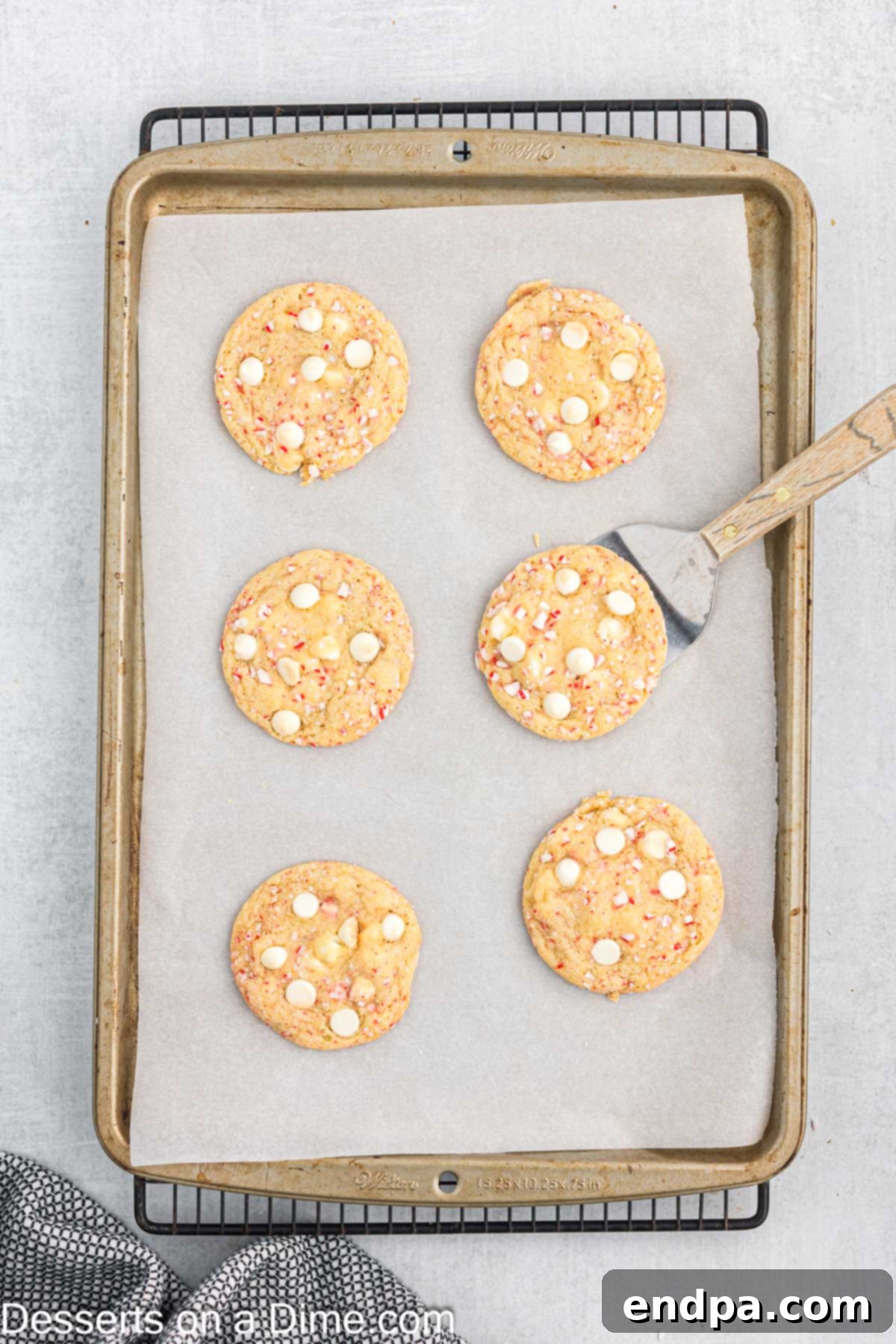 Peppermint White Chocolate Delights 10 Cookies on baking sheet cooling.