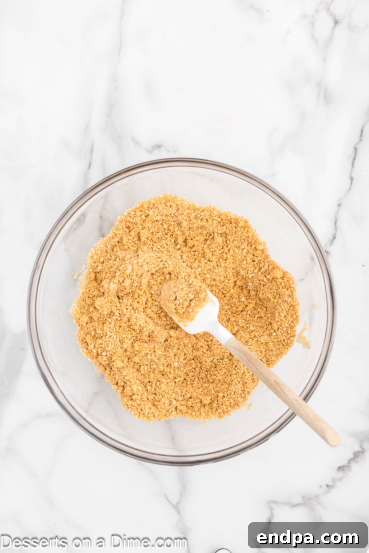 Bowl of graham cracker crumbs, sugar, and melted butter mixed together.