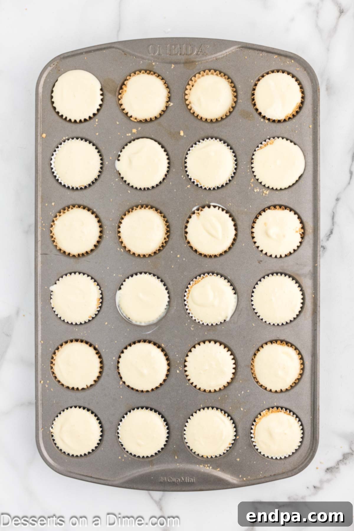 Cupcake pan filled with cream cheese mixture over the crusts.