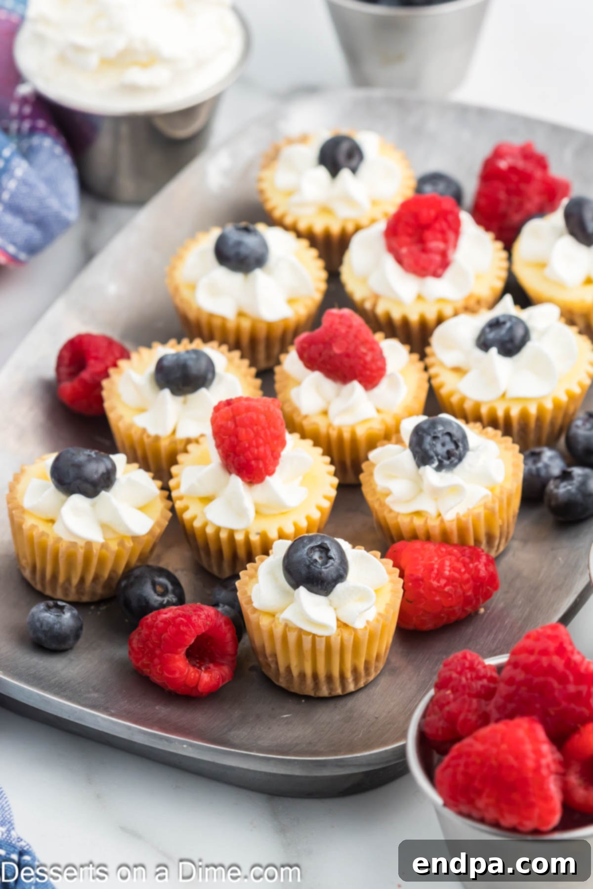 Mini Cheesecake Bites up close with fresh fruit on a platter, ready to be served.