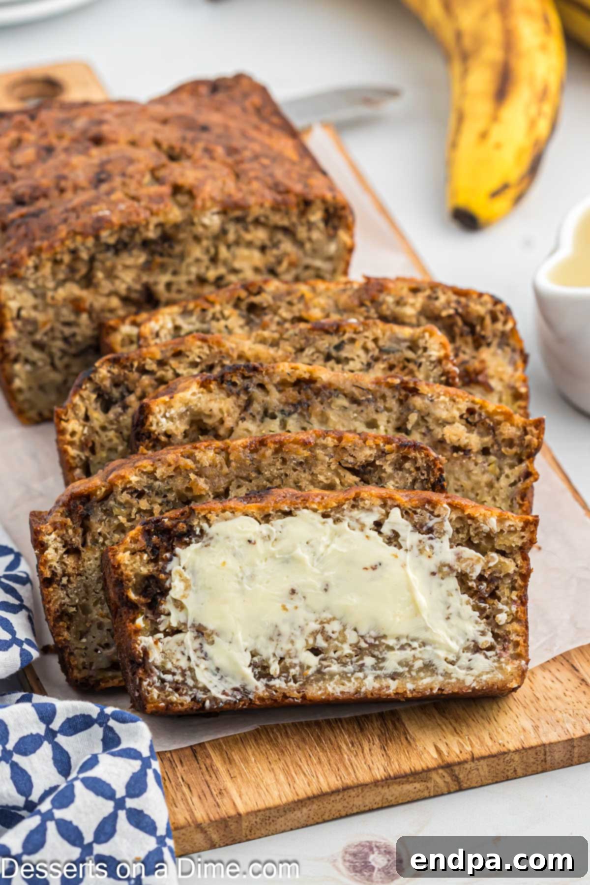 Slices of perfectly golden-brown banana bread with applesauce, lightly buttered and ready to enjoy.