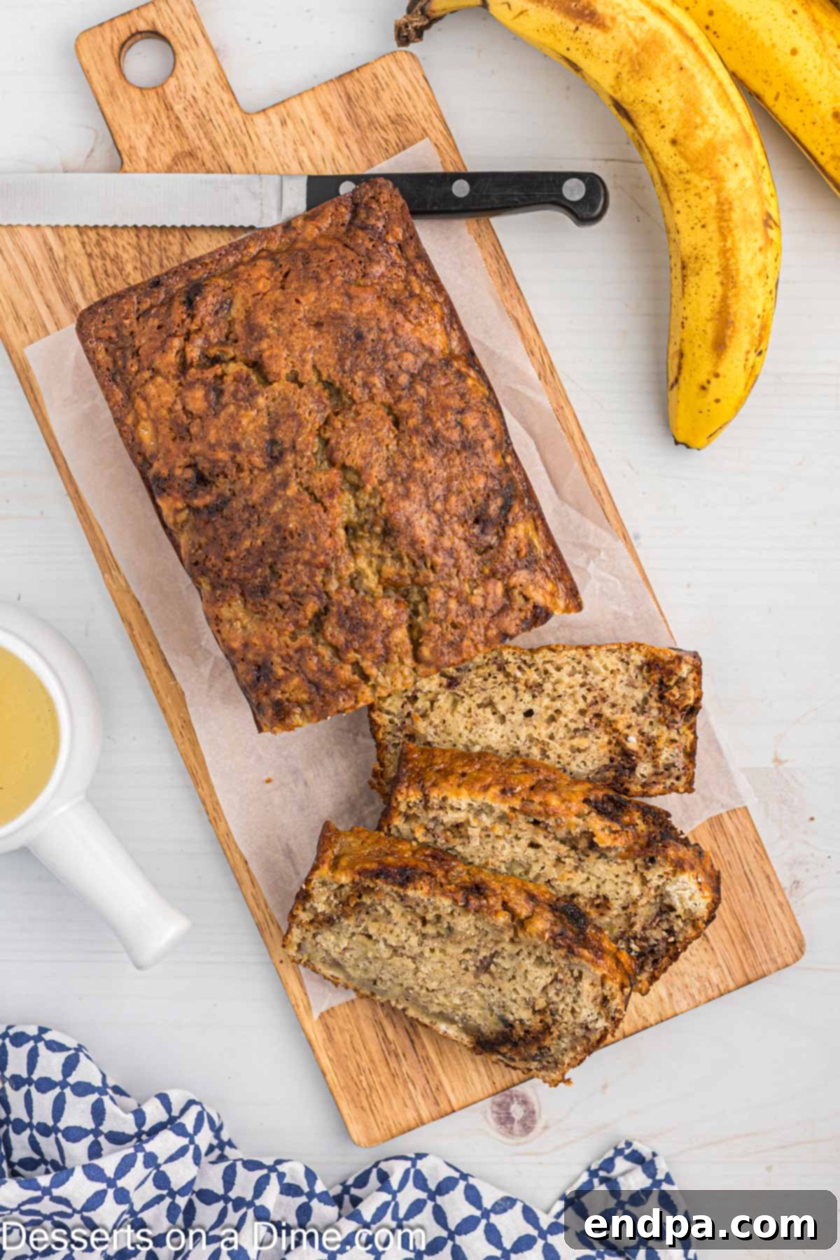 Slices of warm, moist banana bread with applesauce, served on a cutting board, ready to be eaten.
