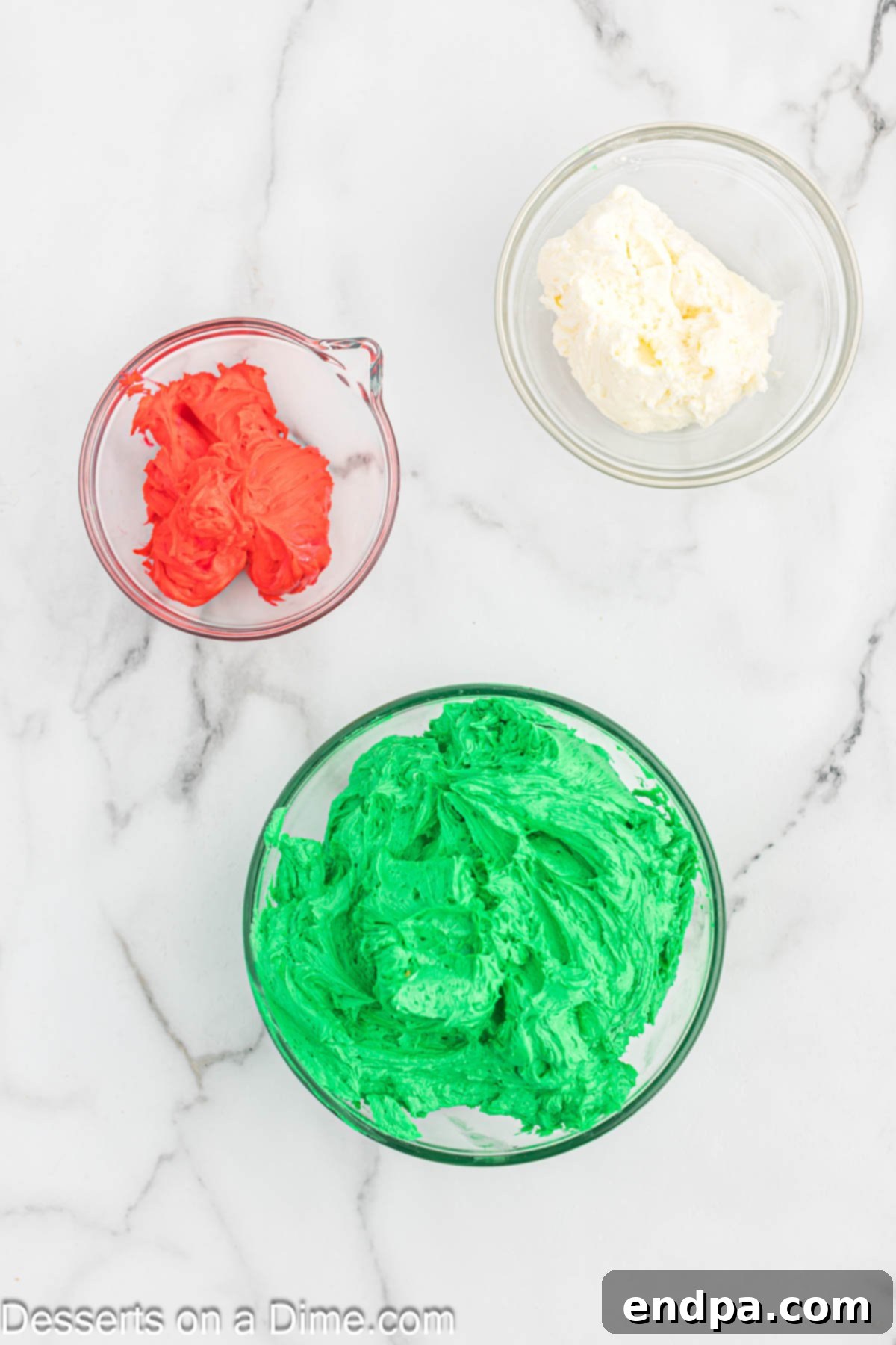 Gaudiest Garment Bake 7 Three separate bowls containing red, white, and green frosting.