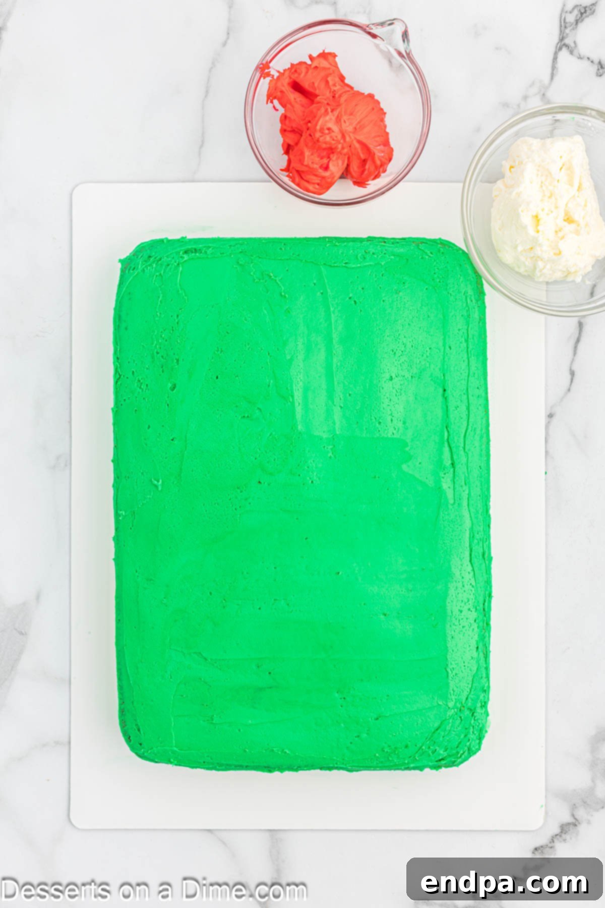 Gaudiest Garment Bake 8 Cake fully covered with green frosting on the top and sides, resembling a base sweater.