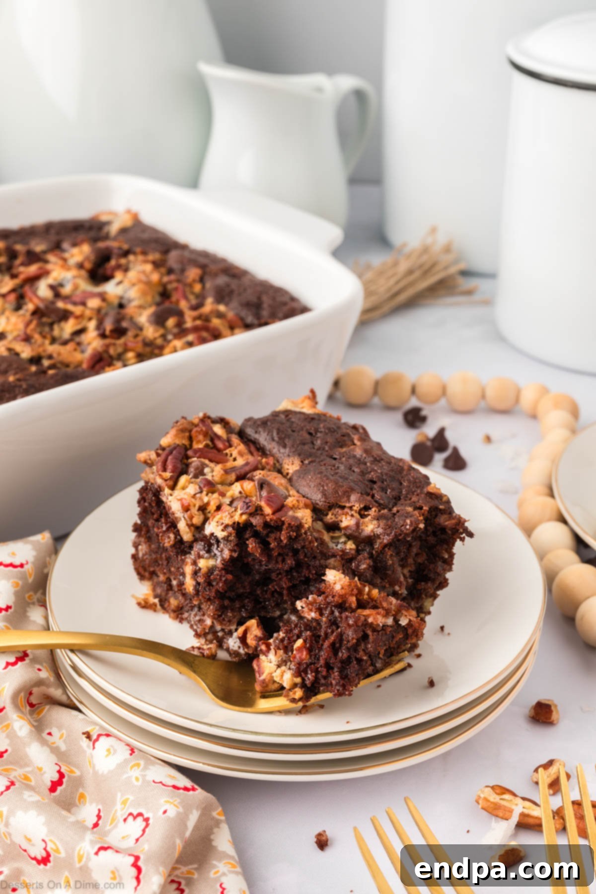 One-Pan German Chocolate Cake 2 German chocolate dump cake on plate ready to serve, topped with a dollop of cream.