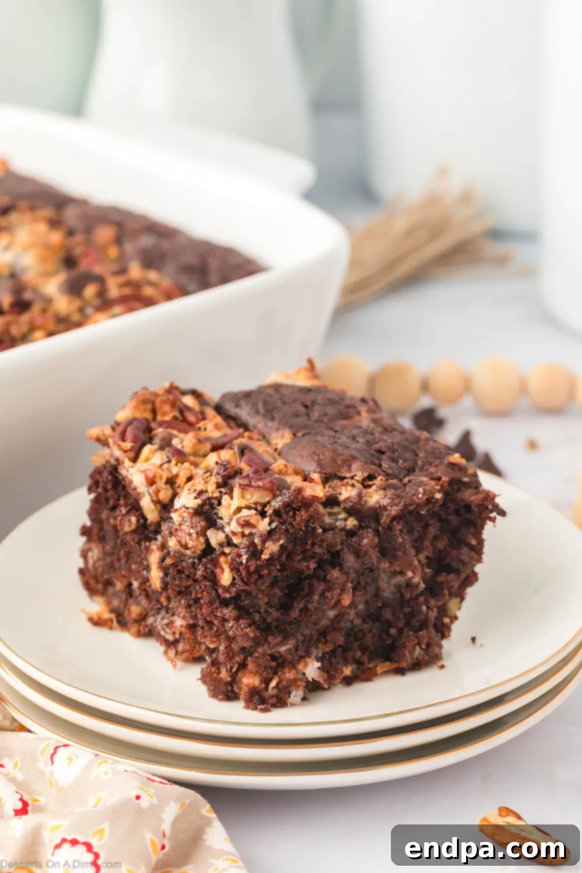 One-Pan German Chocolate Cake 13 Close-up of a slice of German chocolate dump cake with a fork, showing the layers of chocolate, coconut, and pecans.