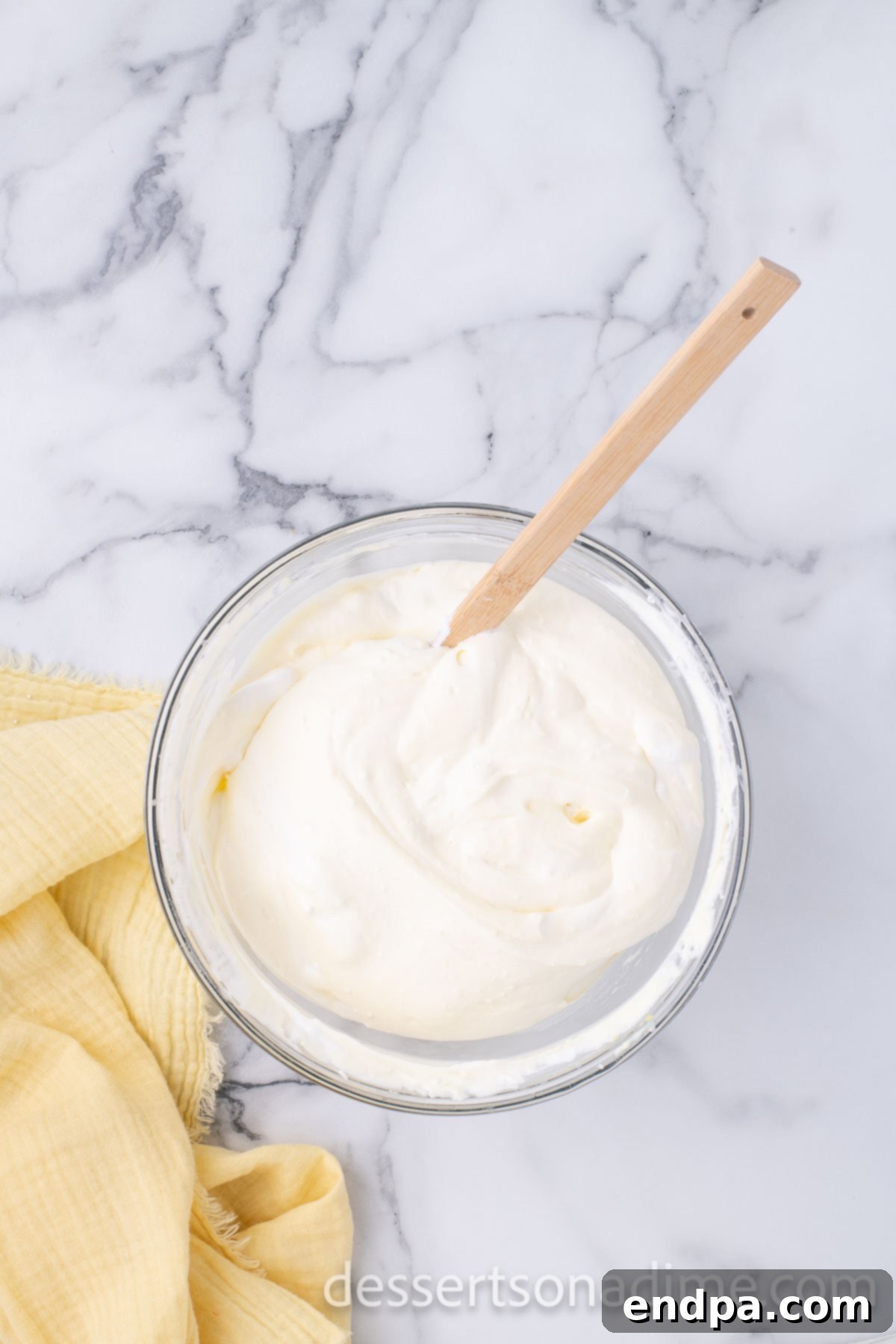 The velvety pudding mixture with light and airy whipped cream gently folded in, creating a harmonious and fluffy consistency.