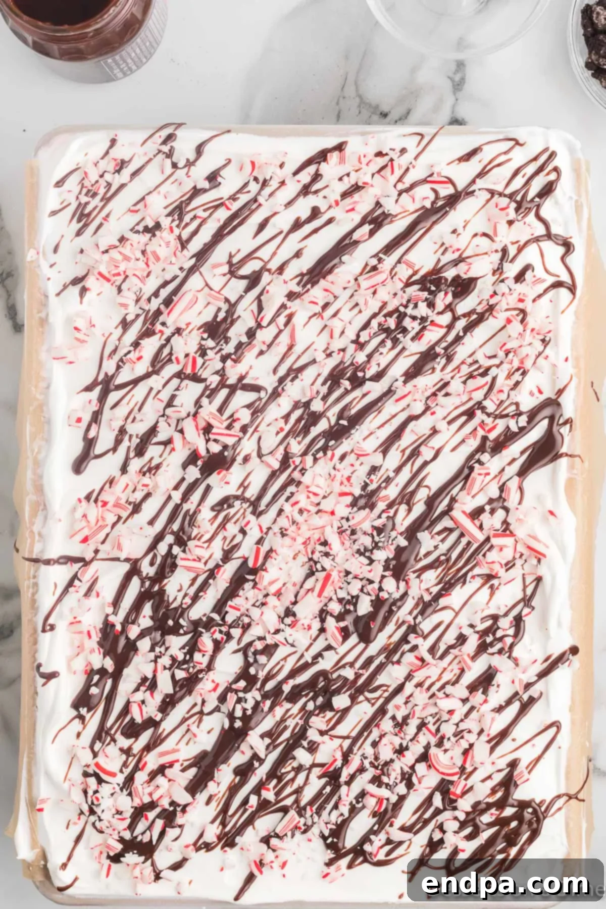 Holly Jolly Ice Cream Cake 11 Christmas ice cream cake topped with hot fudge, crushed candy canes, and reserved Oreo crumbs.