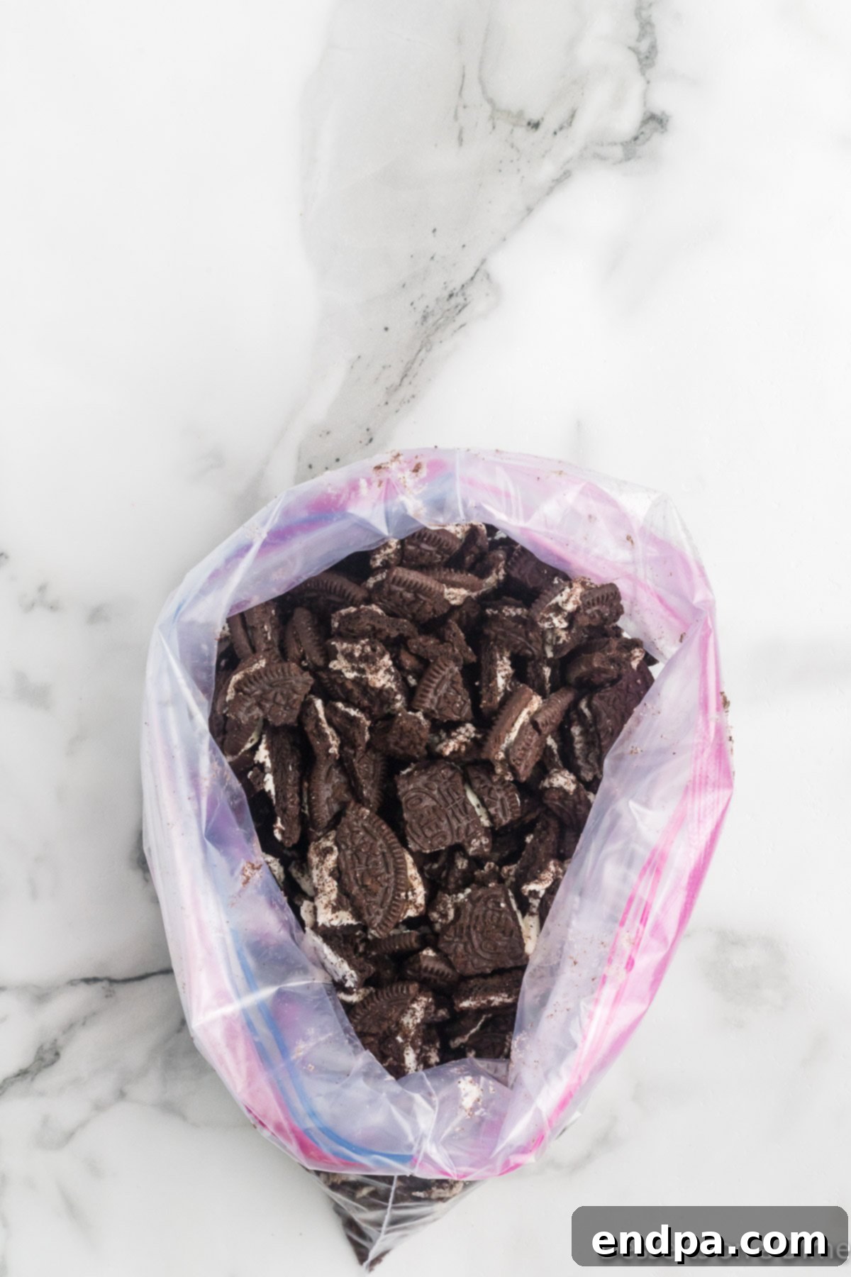 Holly Jolly Ice Cream Cake 5 Crushed Oreo cookies inside a ziplock bag.