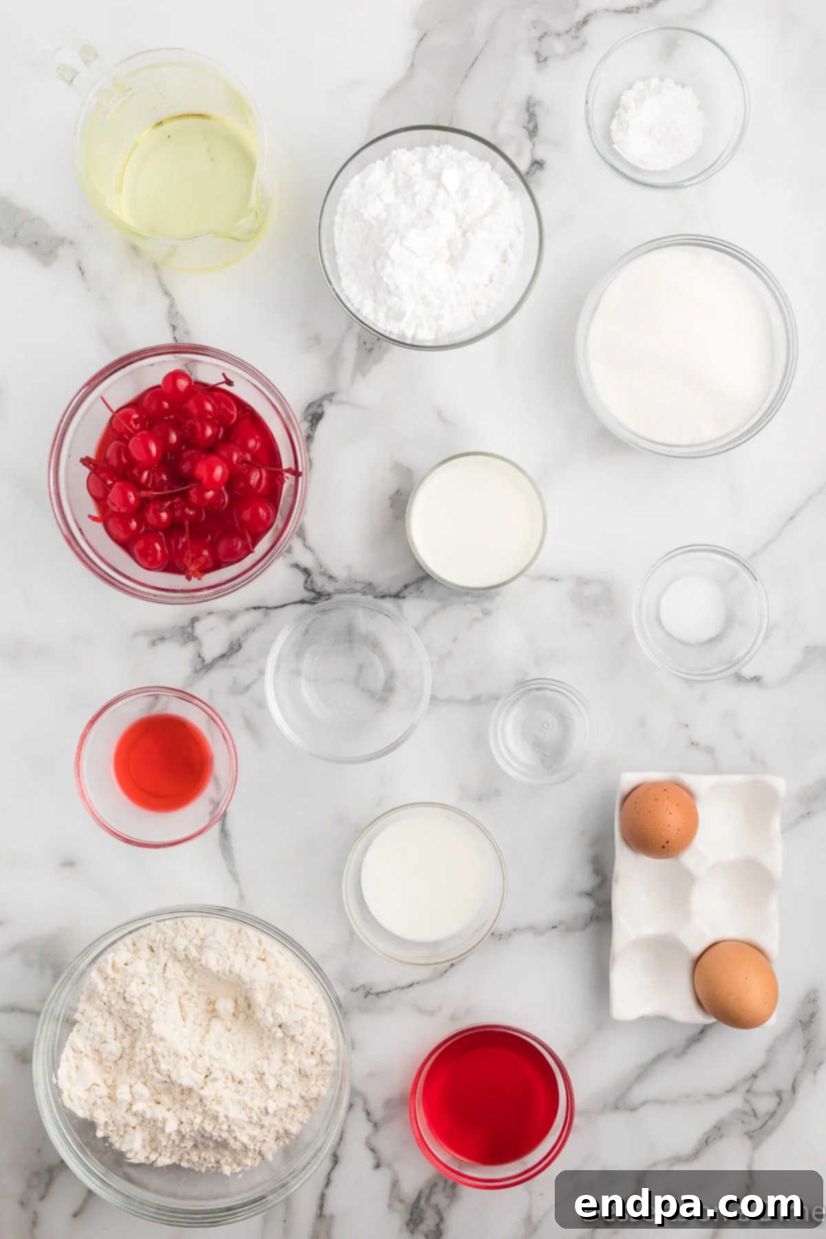 Two loaves of cherry bread, one whole and one sliced, resting on a wooden cutting board.