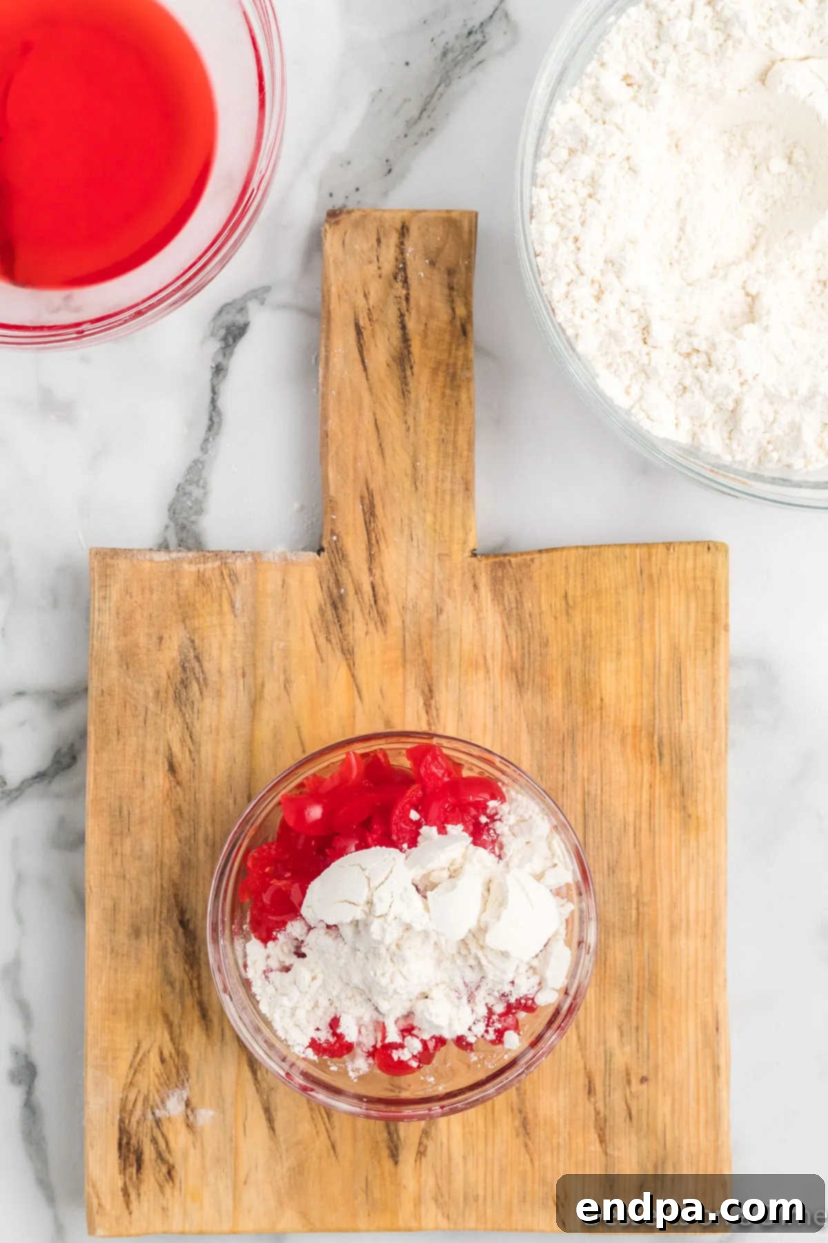 Chopped cherries lightly coated in flour in a mixing bowl.