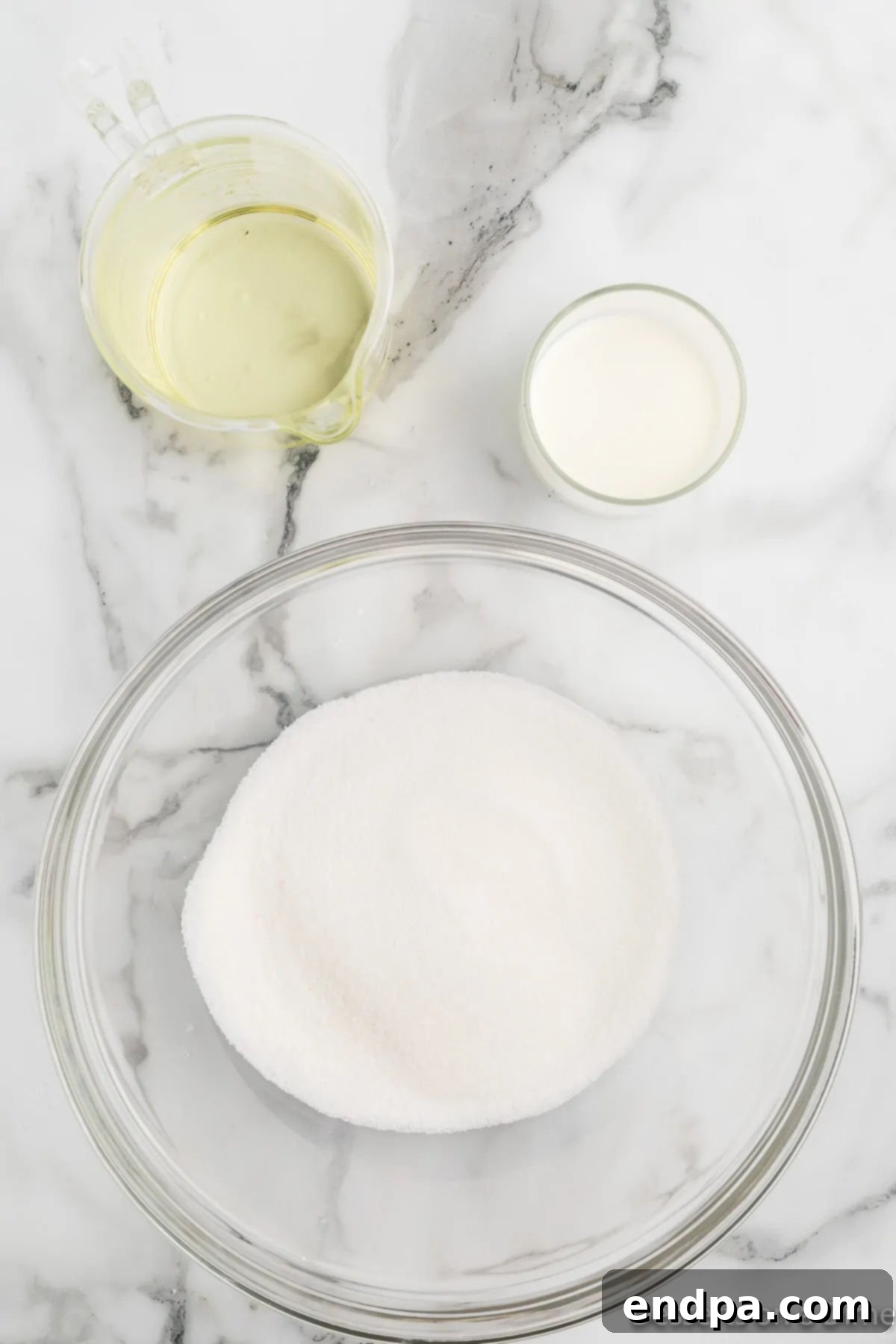 A mixing bowl containing flour, baking powder, and salt, ready to be whisked.