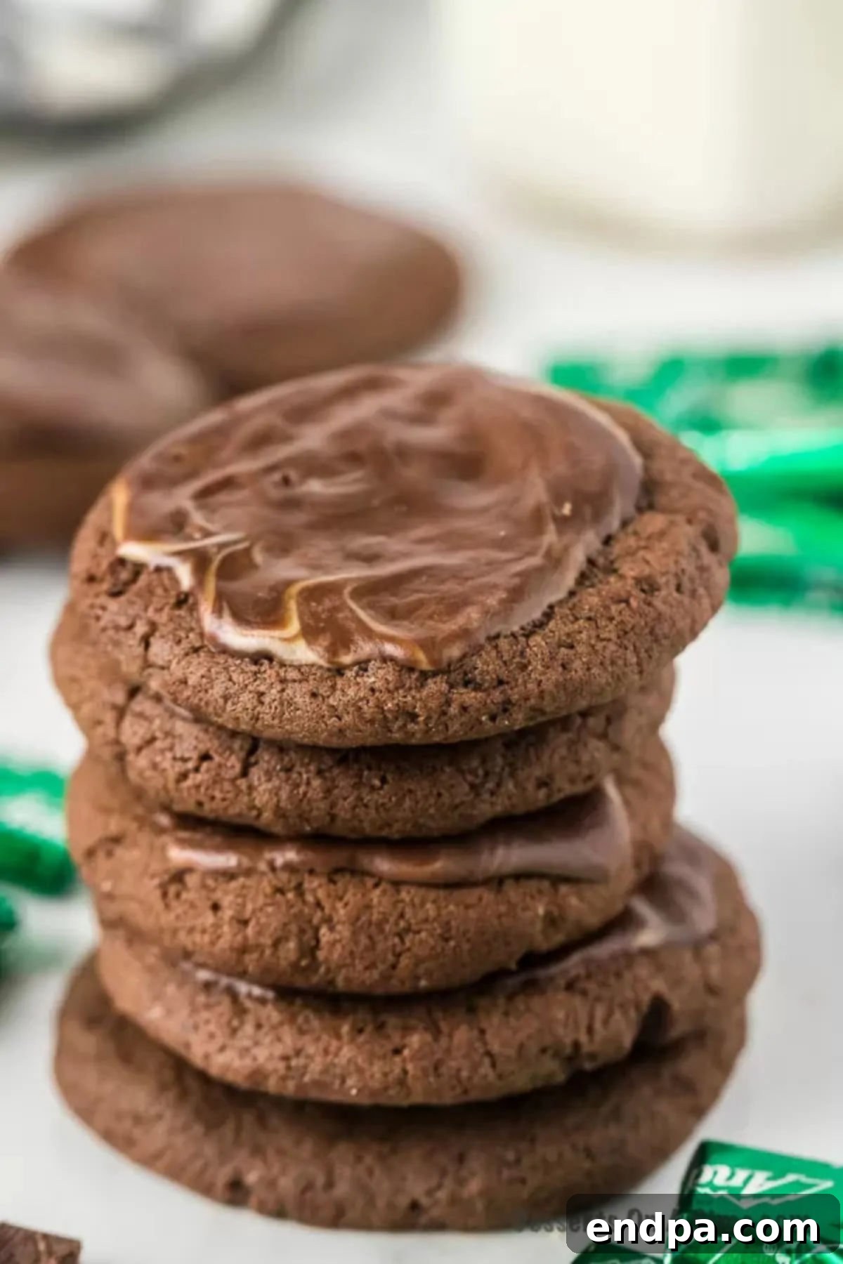 A stack of perfectly baked Andes Mint Cookies, showcasing their rich chocolate base and glossy, melted mint topping, ready to be served.