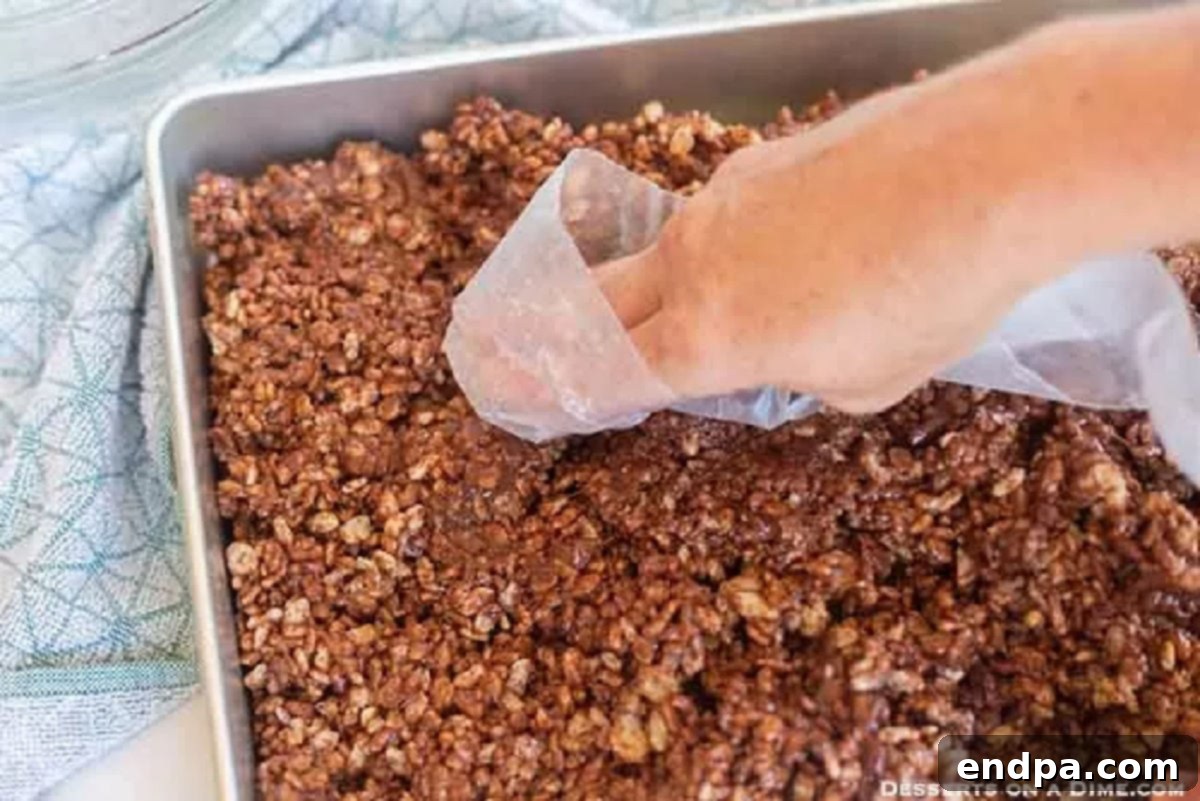 The chocolate cereal mixture pressed firmly into the prepared baking dish.