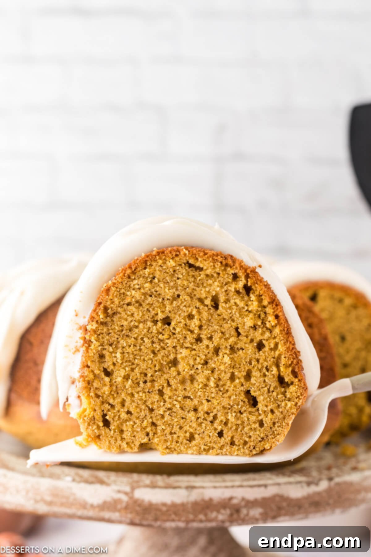 A slice of pumpkin bundt cake being served.