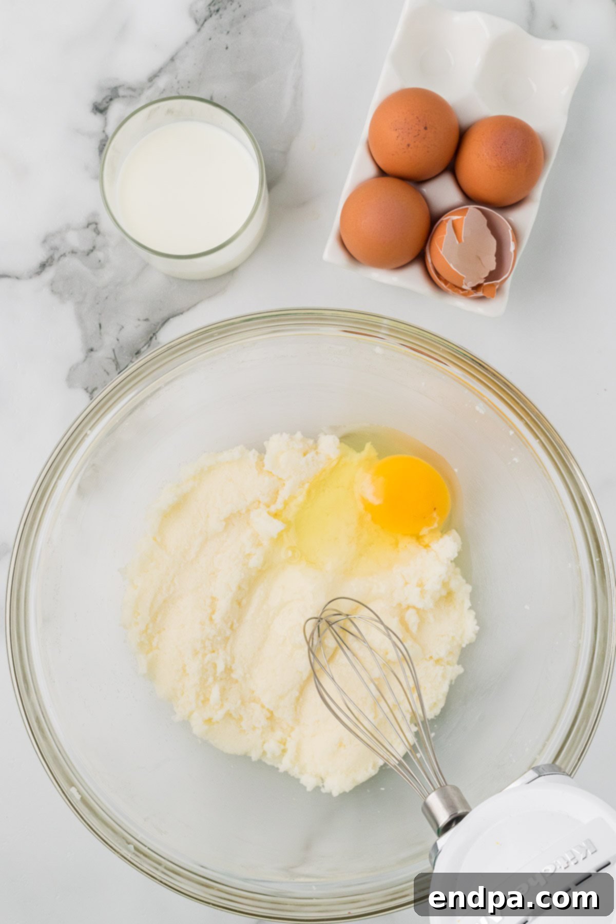 Eggs whisked into the butter and sugar mixture.