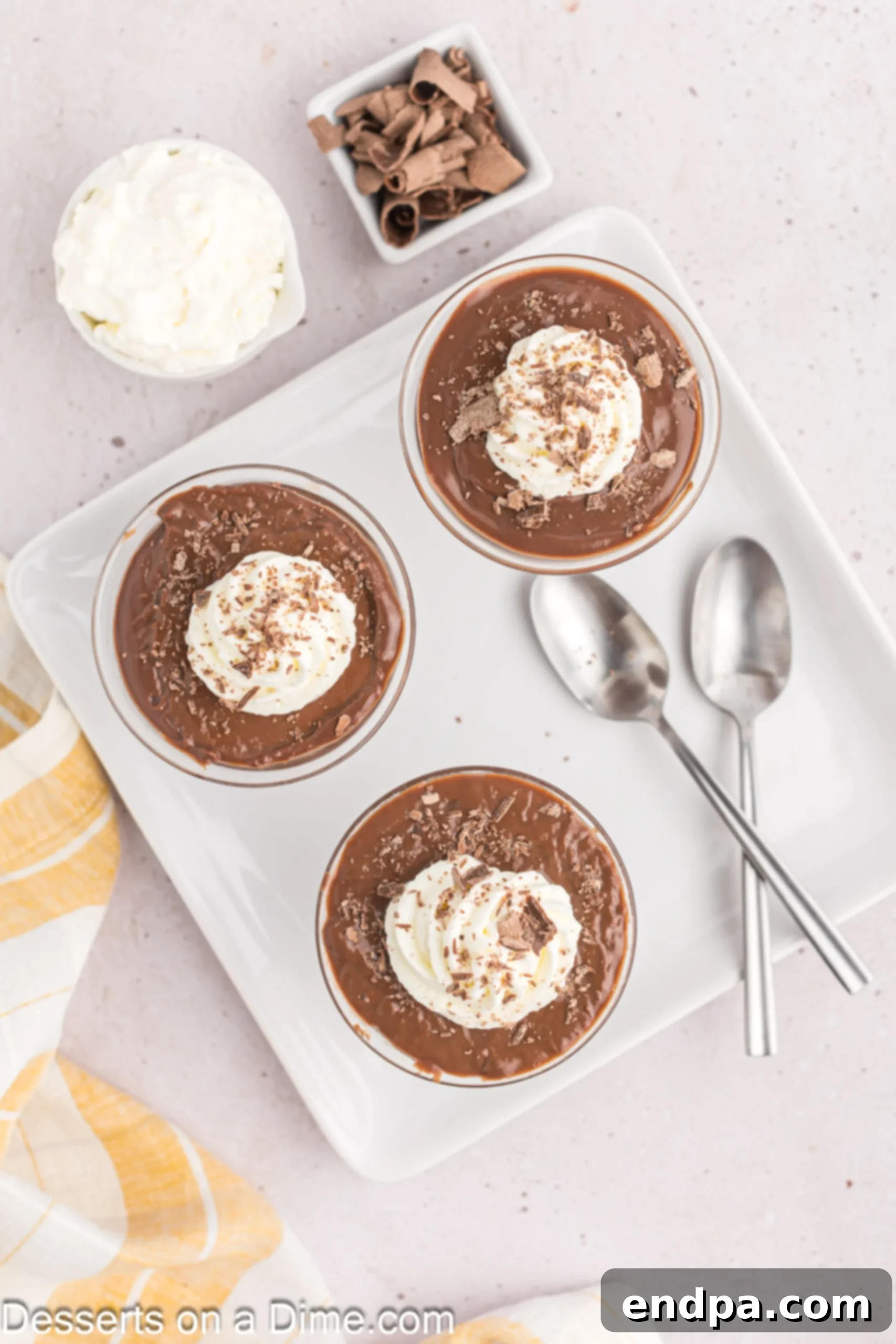 Decadent Chocolate Dream 7 Individual bowls of homemade chocolate pudding topped with generous swirls of whipped cream, ready to serve.