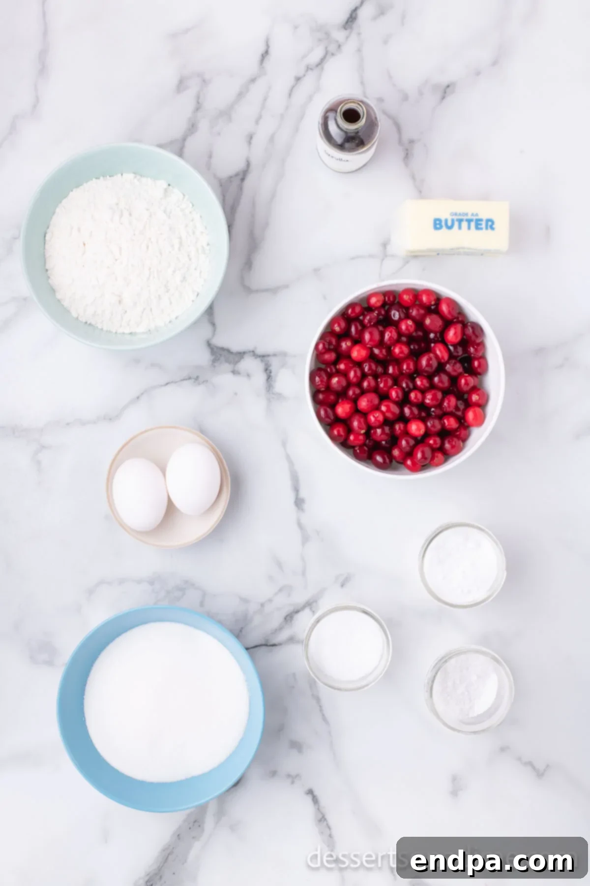 Homemade Sweet-Tart Cranberry Loaf 3 A beautiful flat lay of fresh cranberries, eggs, granulated sugar, vanilla extract, and baking soda, neatly arranged for the cranberry bread recipe.