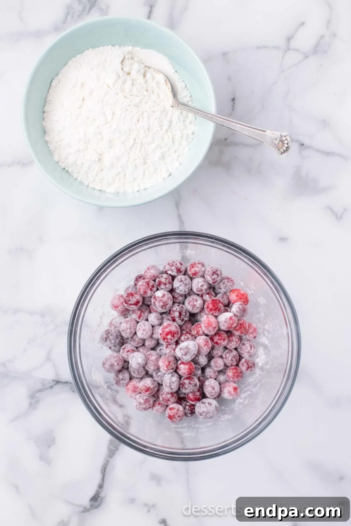 Homemade Sweet-Tart Cranberry Loaf 4 Fresh cranberries lightly coated in a small amount of flour in a mixing bowl, ready to be added to the bread batter.