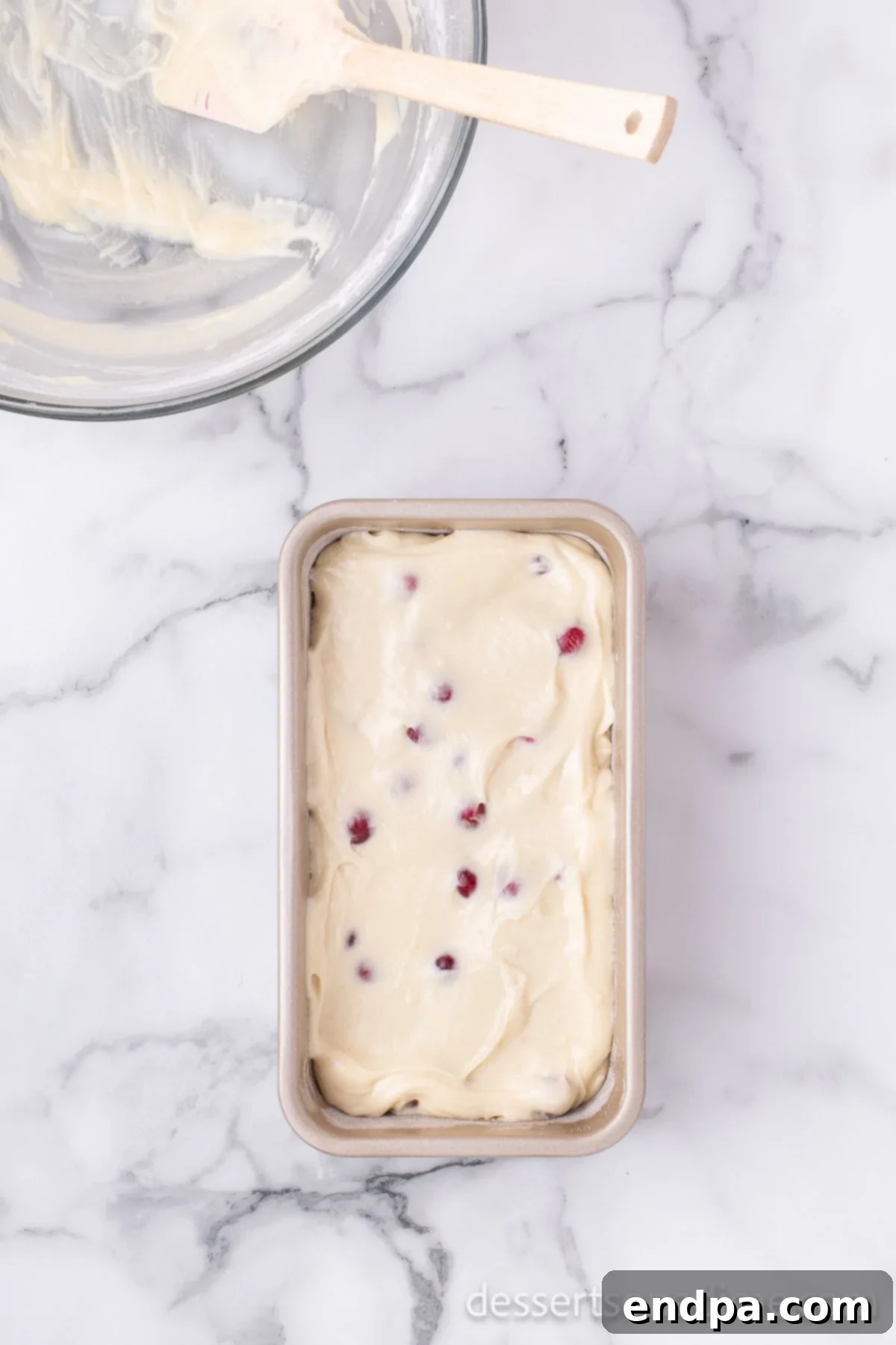 Homemade Sweet-Tart Cranberry Loaf 9 The cranberry bread batter perfectly poured into a prepared loaf pan, ready for baking in the preheated oven.
