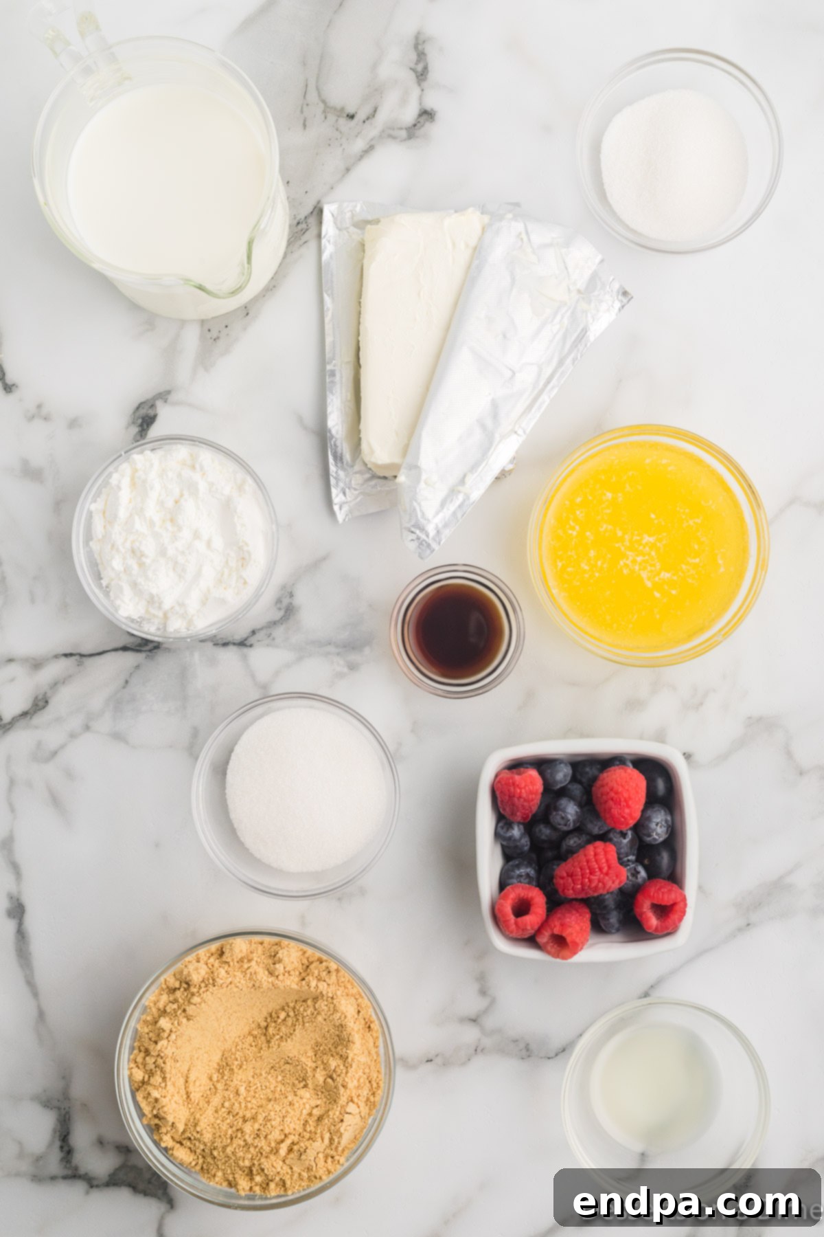 Ingredients for Cheesecake Pudding including graham cracker crumbs, butter, fresh fruit, sugar, vanilla, cream cheese, and cornstarch.