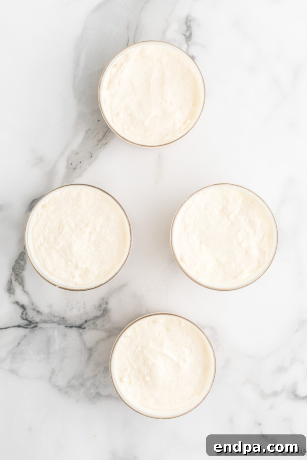 Bowls with cheesecake filling.