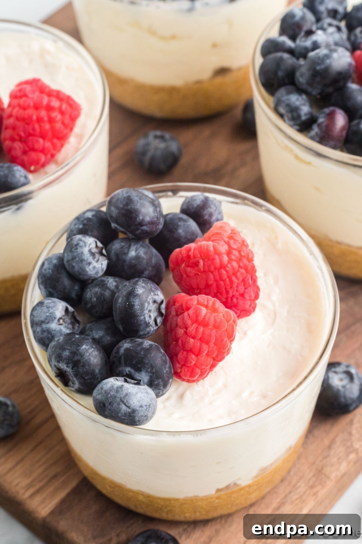 Cup with cheesecake pudding and fresh berries ready to eat.