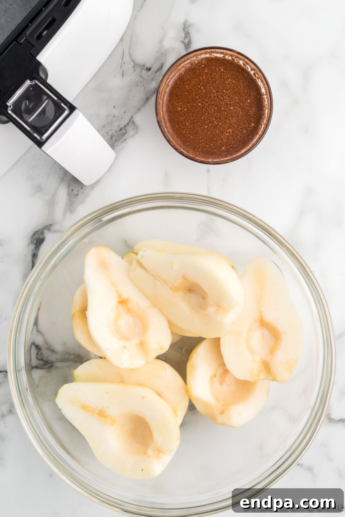 Pear halves placed in a large mixing bowl.