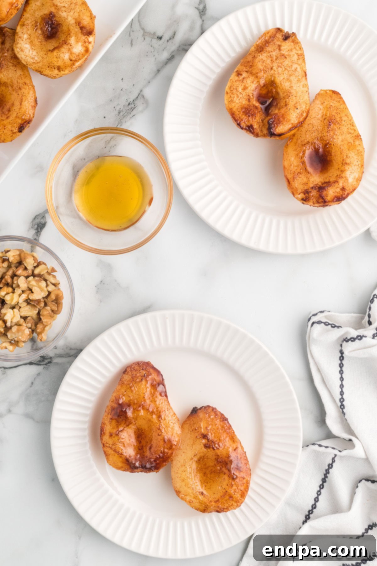 Finished Air Fryer Pears on a plate with toppings, ready to eat.