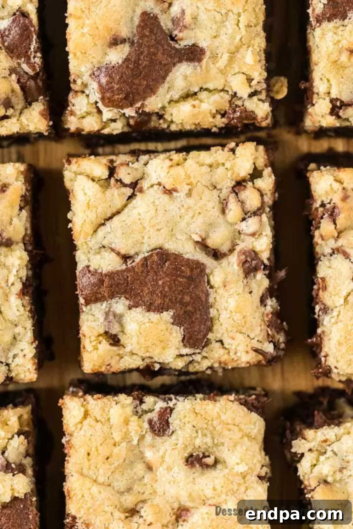 Squares of brookies on a cutting board, showcasing the distinct brownie and cookie layers.