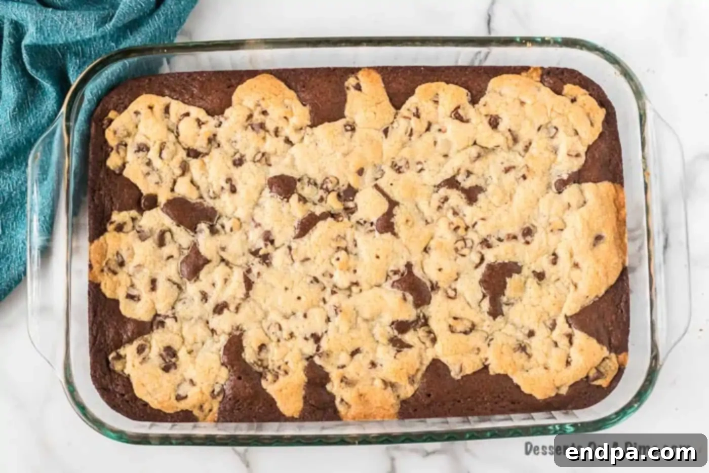 Freshly baked brookie bars cooling in the dish, with golden brown cookie tops.