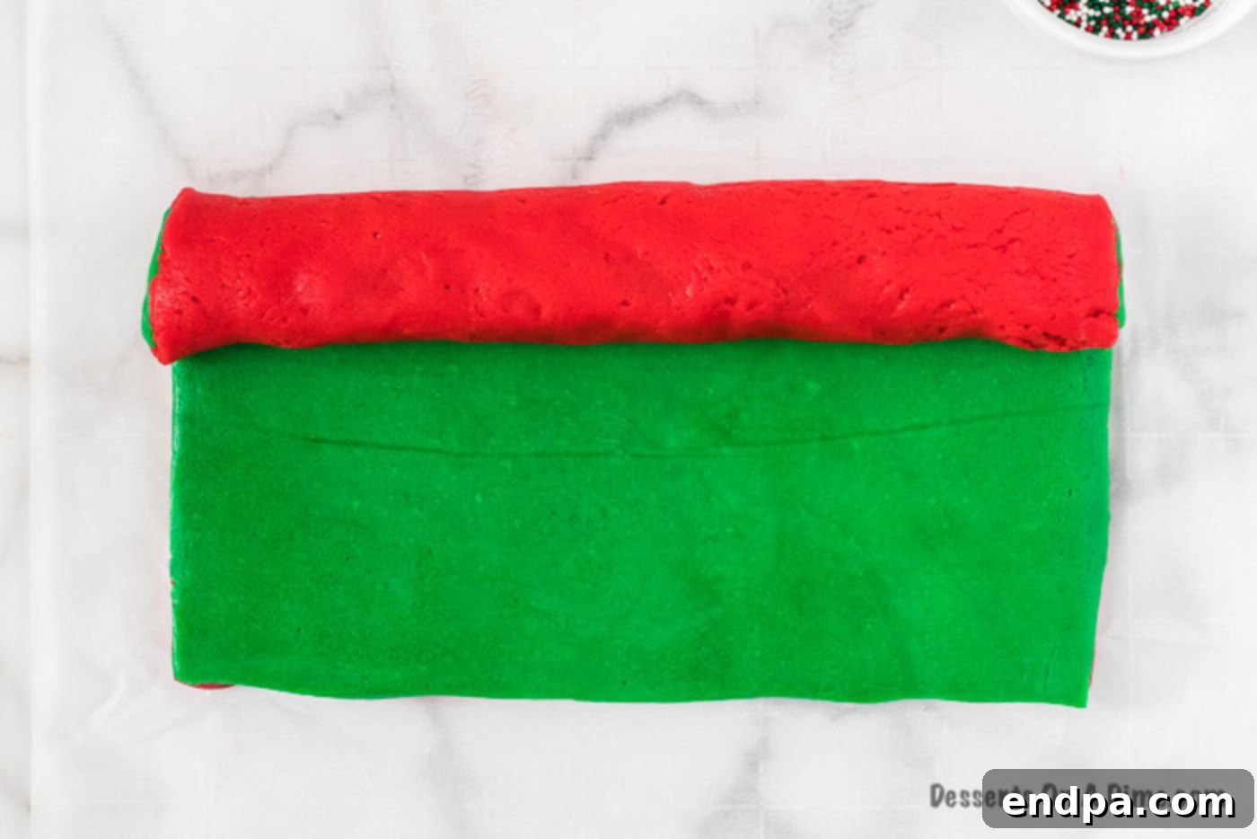 Green cookie dough layered over red cookie dough