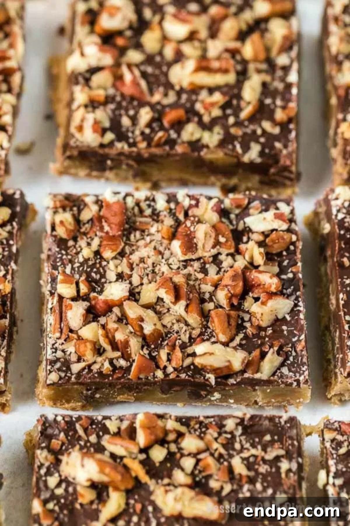 A close-up view of a piece of Graham Cracker Toffee, showing its distinct layers and textures.