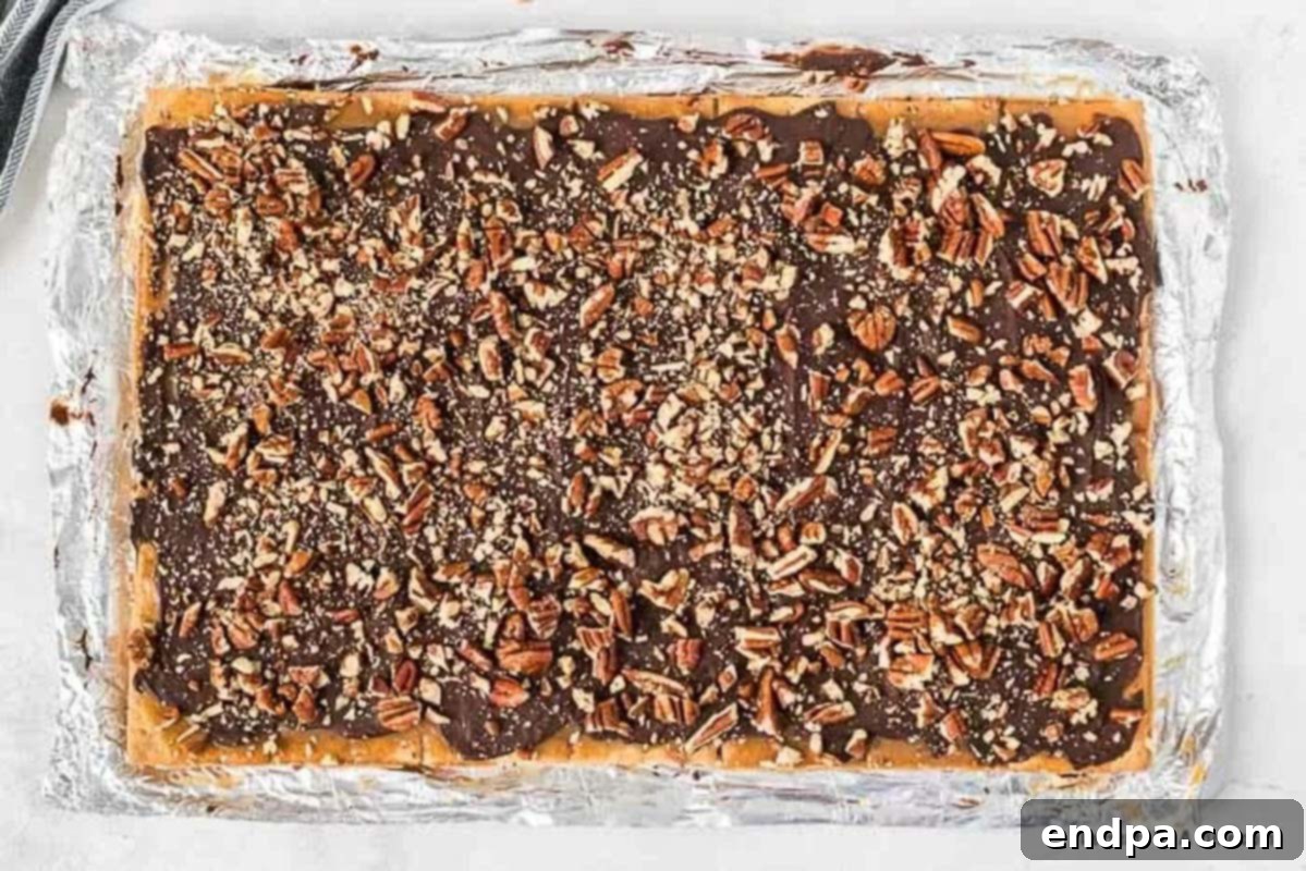Chopped pecans sprinkled over the smooth, melted chocolate layer on the graham cracker toffee.